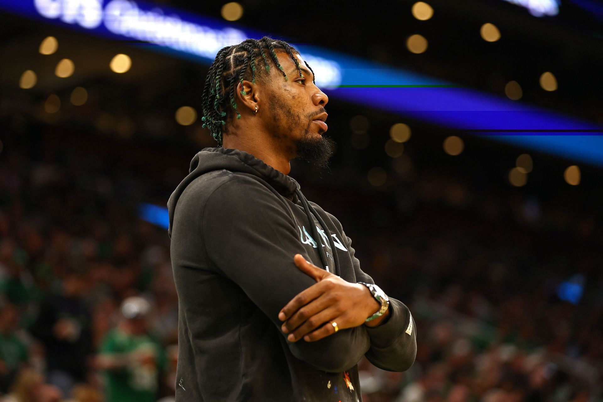 Marcus Smart of the Boston Celtics looks on from the bench.