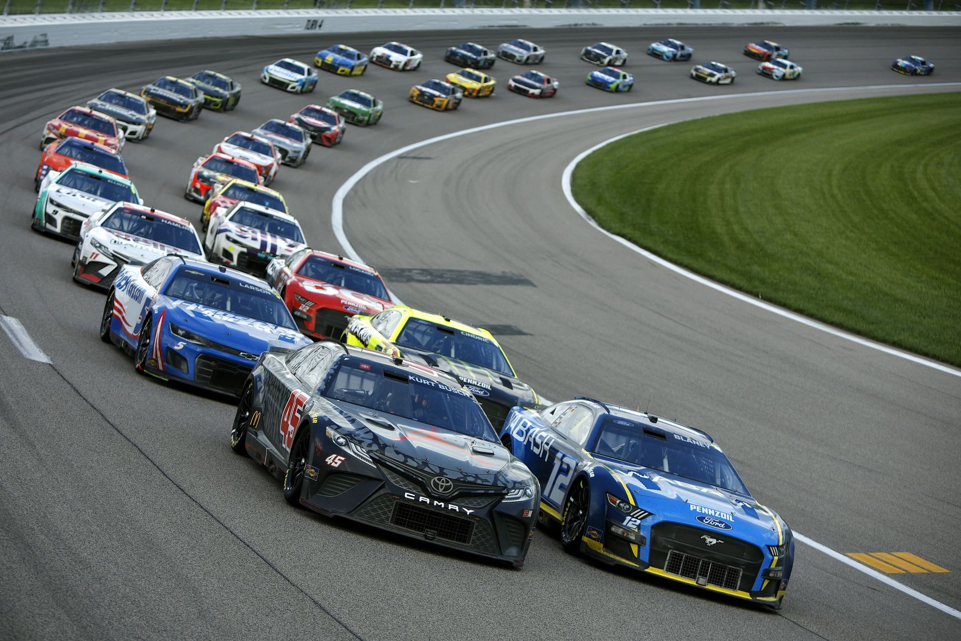 Kurt Busch, Ryan Blaney, Austin Cindric, and Kyle Larson, race during the NASCAR Cup Series AdventHealth 400 at Kansas Speedway (Photo by Sean Gardner/Getty Images)