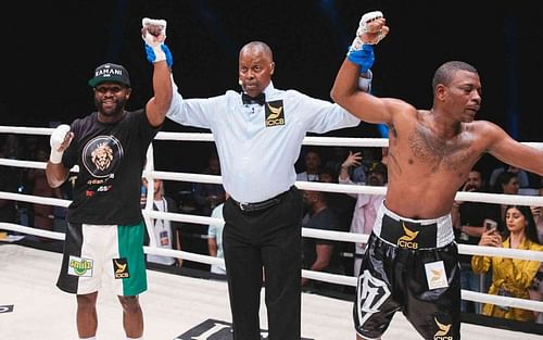 Floyd Mayweather (left) and Don Moore (right), get their hands raised by Kenny Bayless (center)