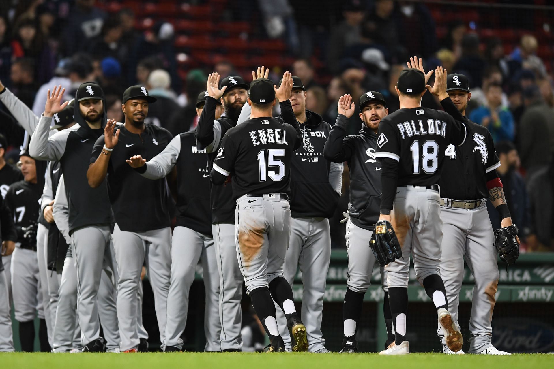 Adam Engel and AJ Pollock of the Chicago White Sox high-five teammates after beating the Boston Red Sox.