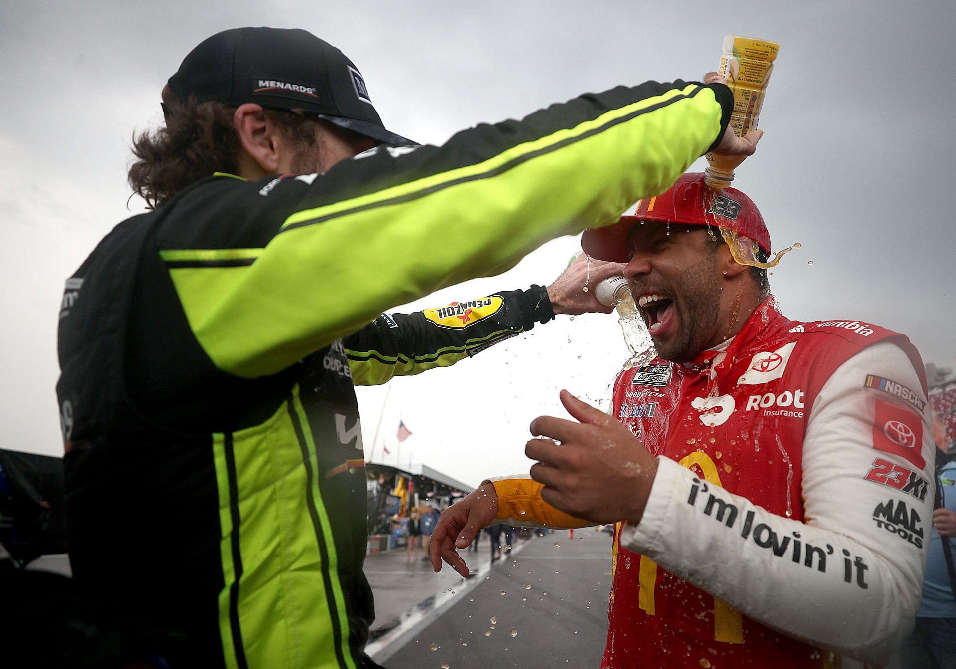 Bubba Wallace Jr. (right) celebrates with Ryan Blaney (left) on the grid after winning the 2021 NASCAR Cup Series YellaWood 500 at Talladega Superspeedway (Photo by Chris Graythen/Getty Images)