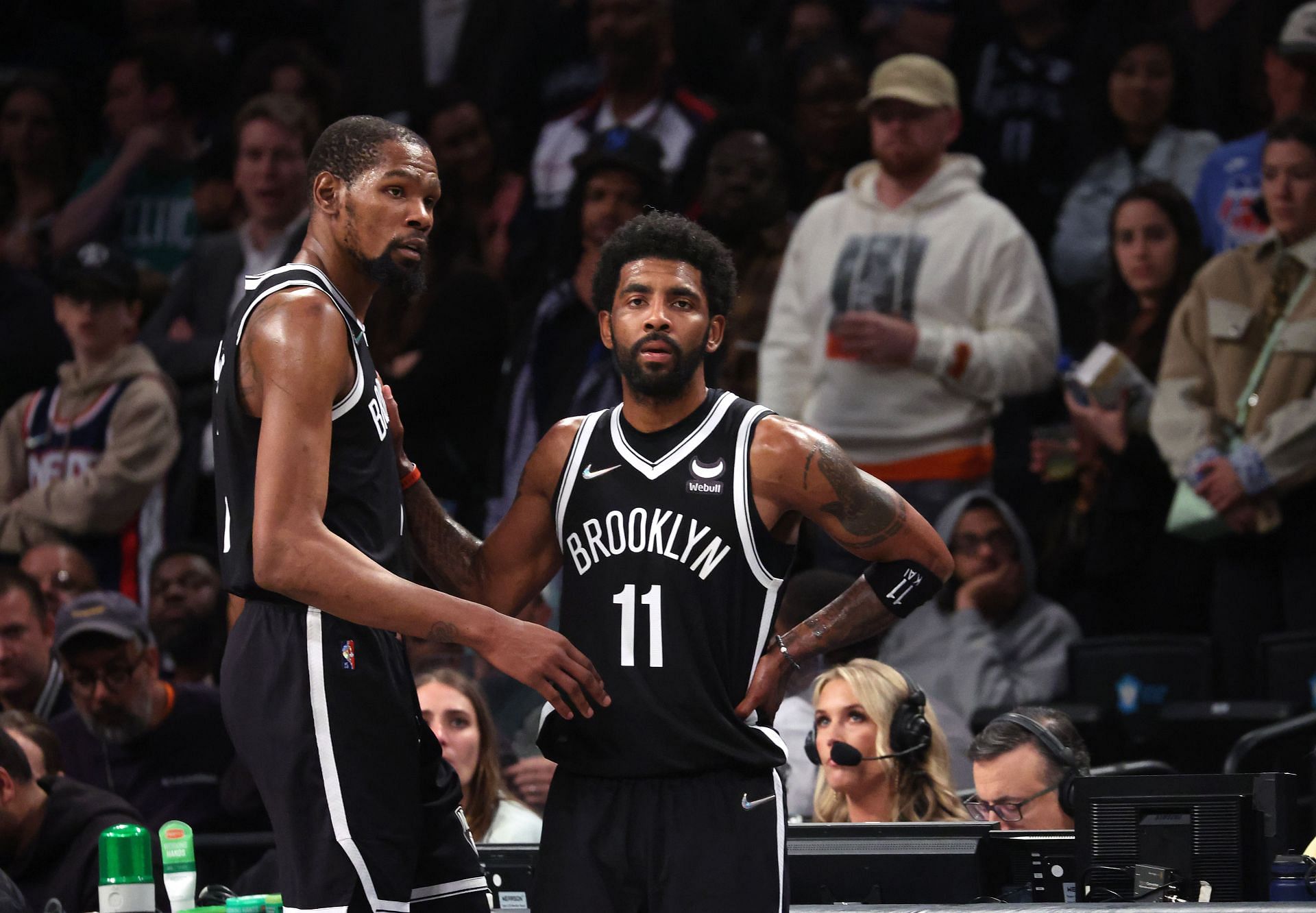 Kyrie Irving discusses the game with Kevin Durant.