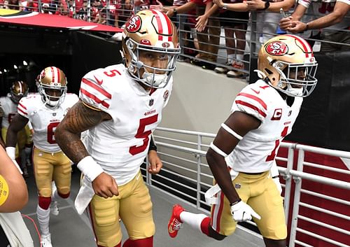 San Francisco 49ers quarterback Trey Lance (left) getting ready to take the field