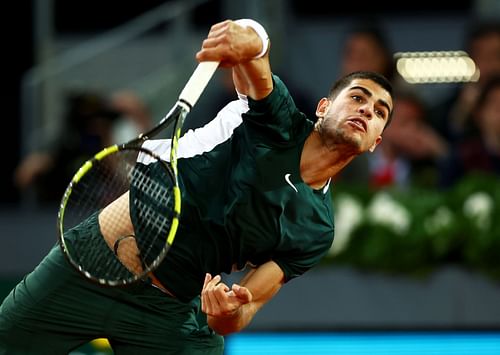 Alcaraz serves in his second round match against Nikoloz Basilashvili during at the 2022 Madrid Open