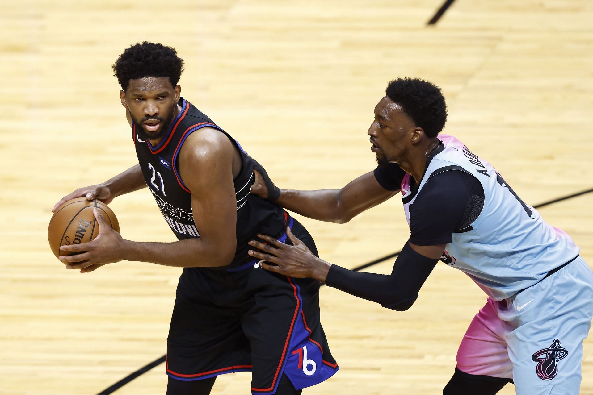 Joel Embiid, left, and Bam Adebayo, right.