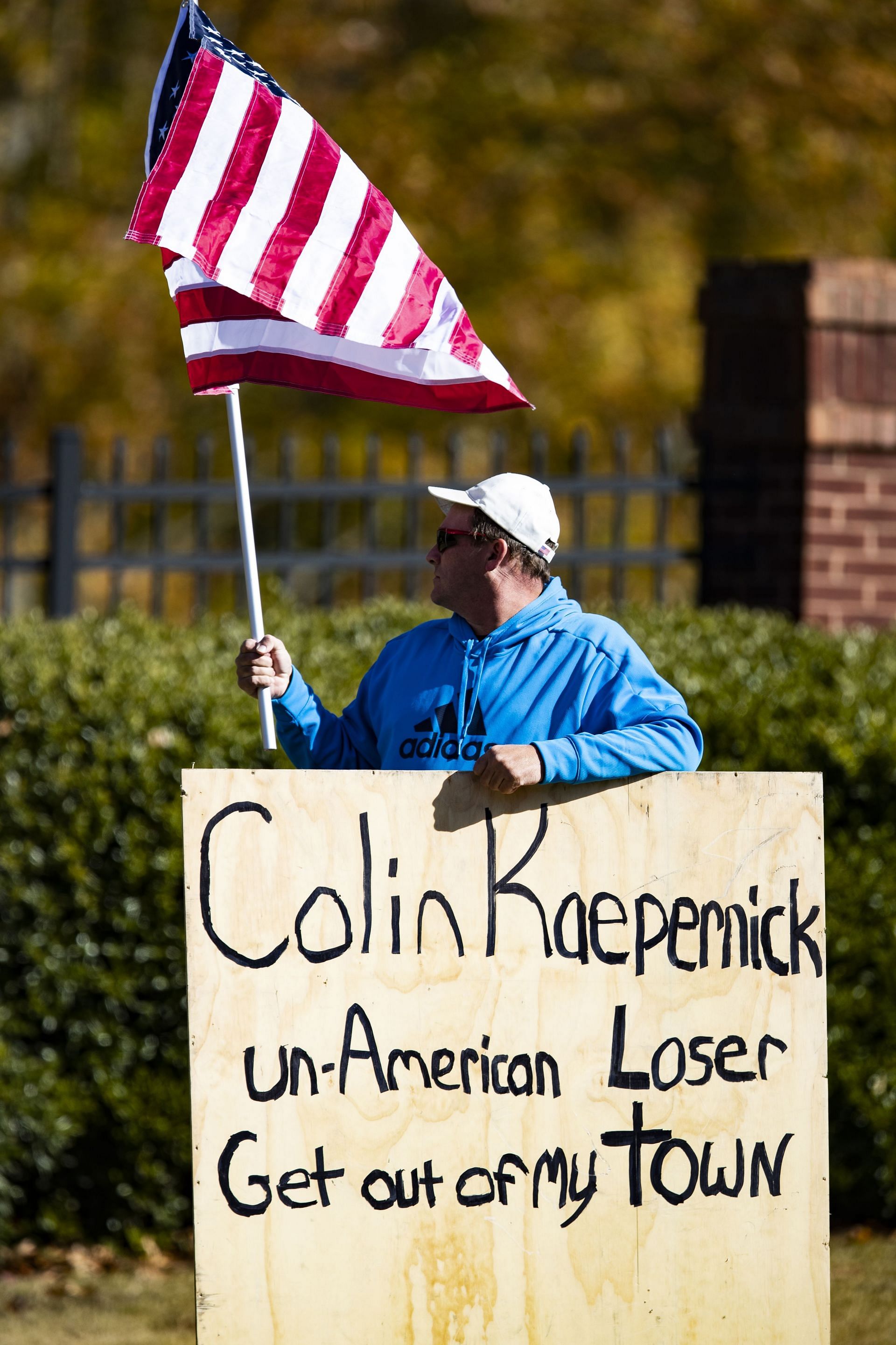 A man waits outside of the training facility where the Colin Kaepernick private NFL workout is being held on November 16, 2019, in Flowery Branch, Georgia