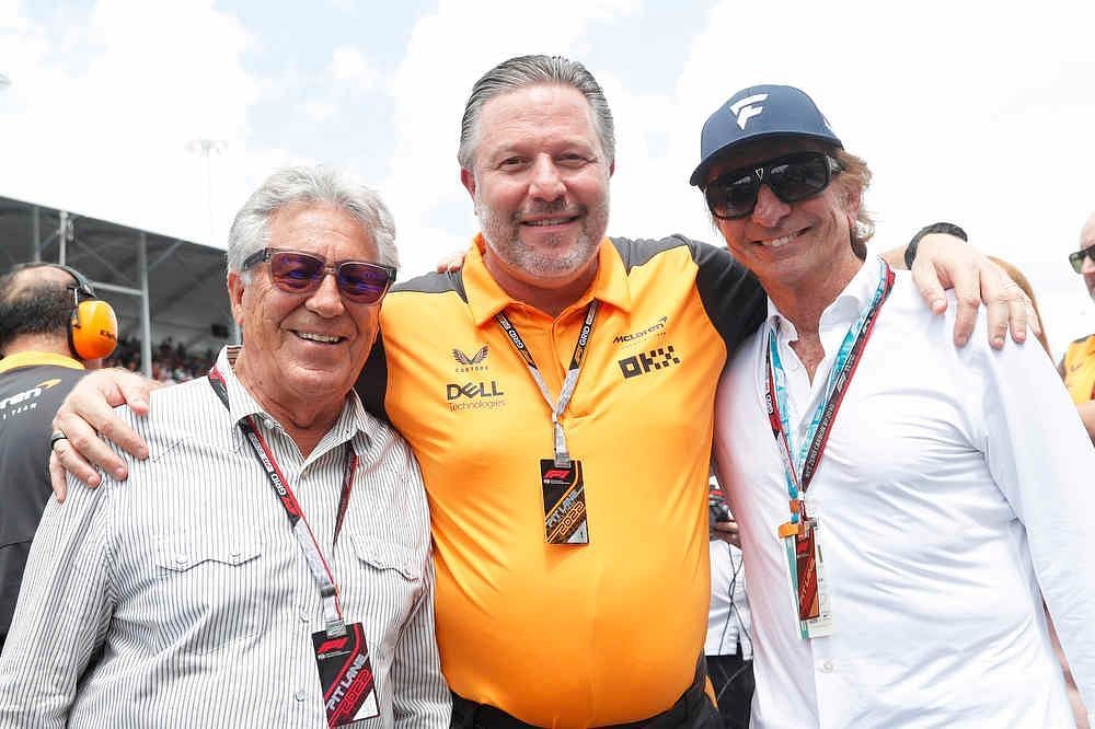 Mario Andretti (left), McLaren CEO Zak Brown (center), and Emerson Fittipaldi (right) on the grid before the 2022 F1 Miami GP (Image Courtesy: @ZBrownCEO on Twitter)