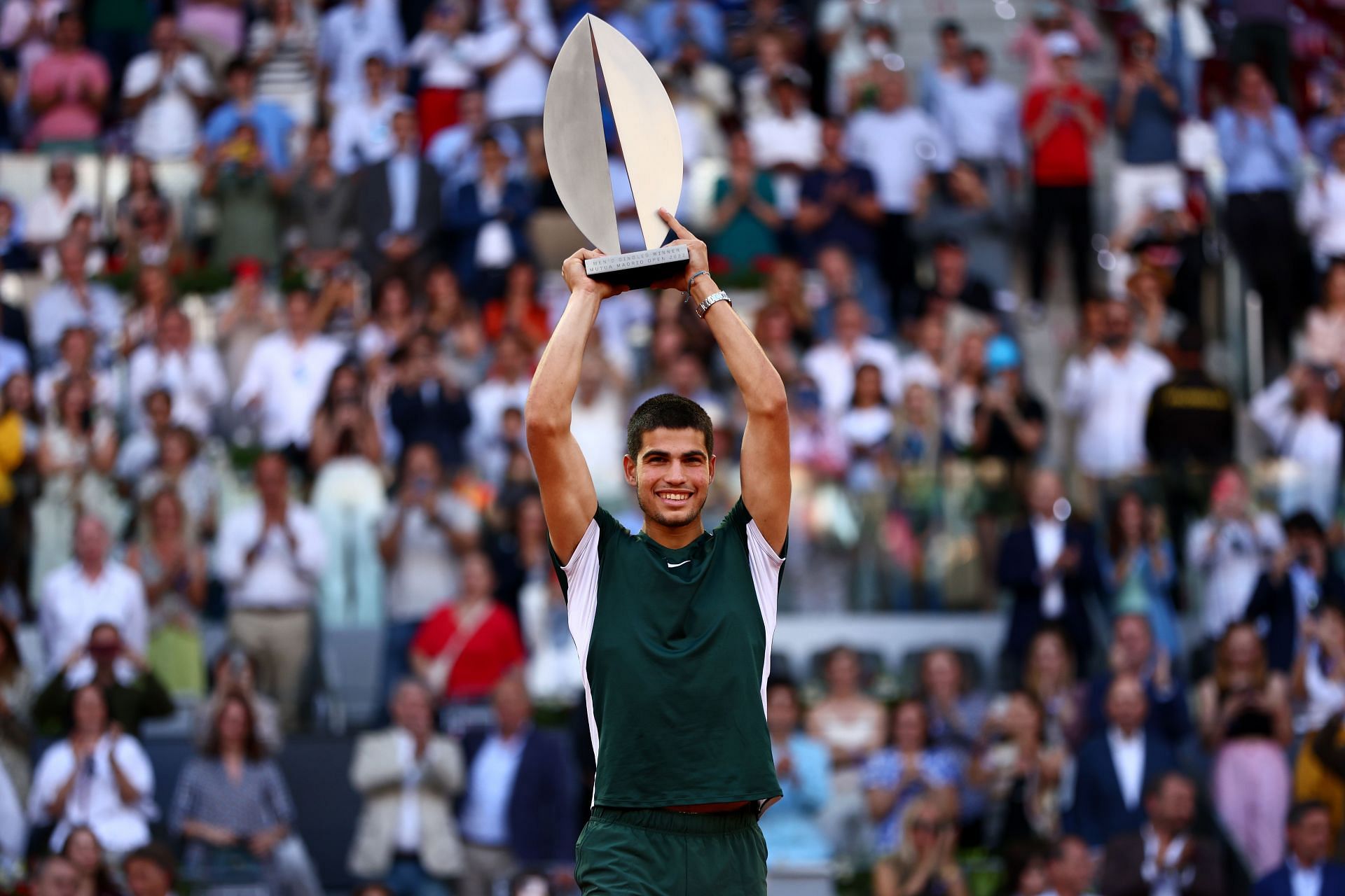 Carlos Alcaraz holding the Madrid Open trophy