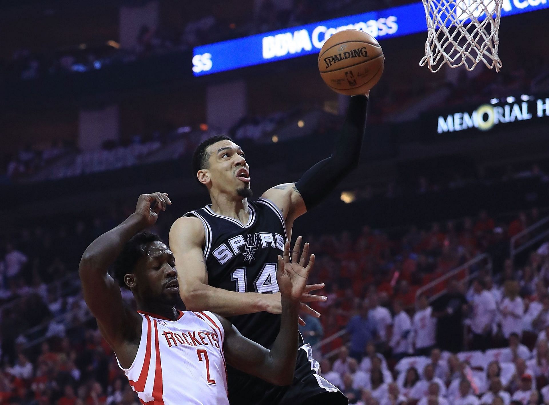 Danny Green of the San Antonio Spurs dunks against Patrick Beverley of the Houston Rockets.