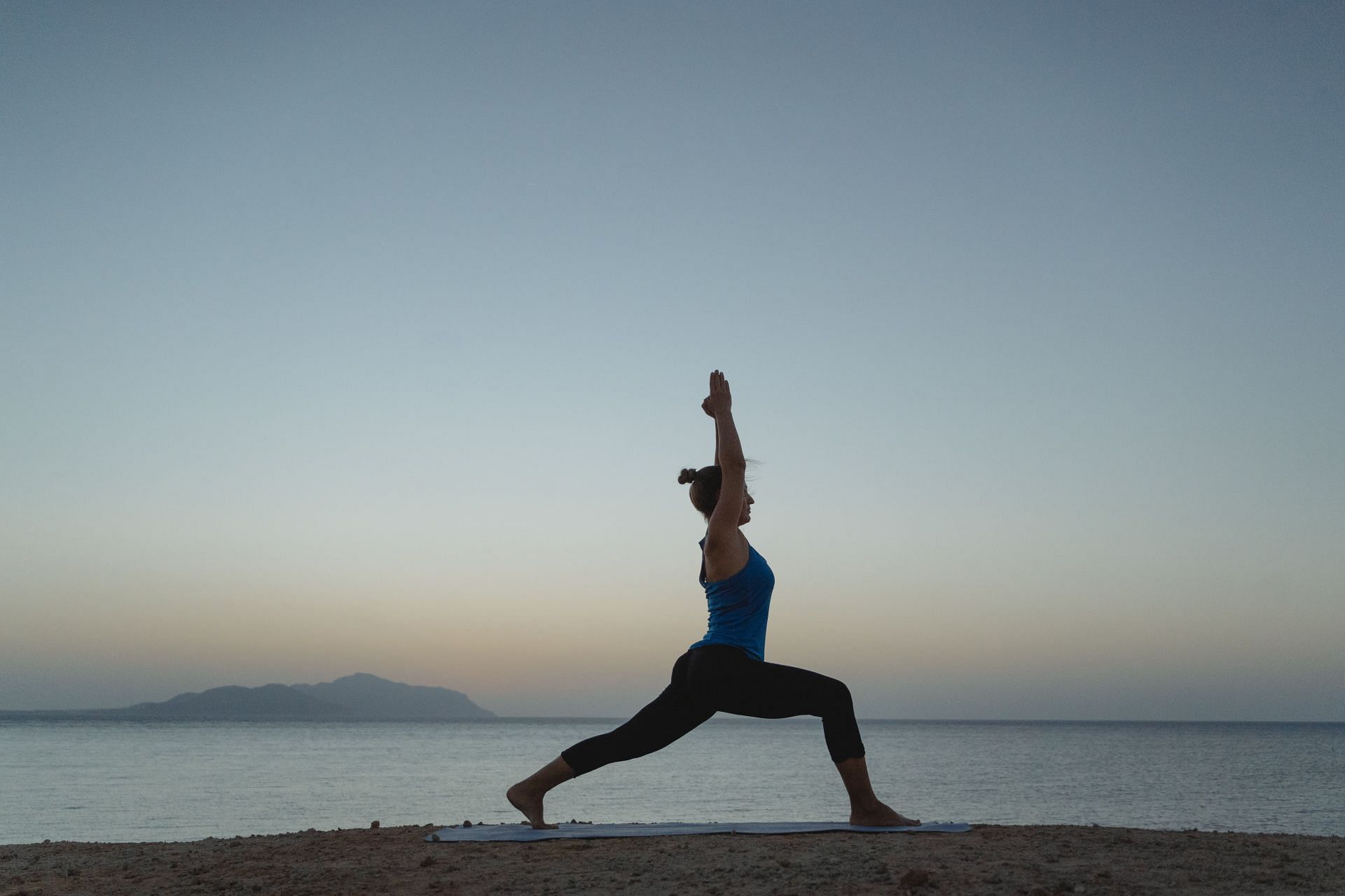 It is essential to stretch the muscles while warming up for yoga. (Image via Pexels / Tima Miroshnichenko )