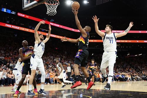 Chris Paul (#3, centre) beats Luka Doncic (#77) to get to the bucket in Game Two