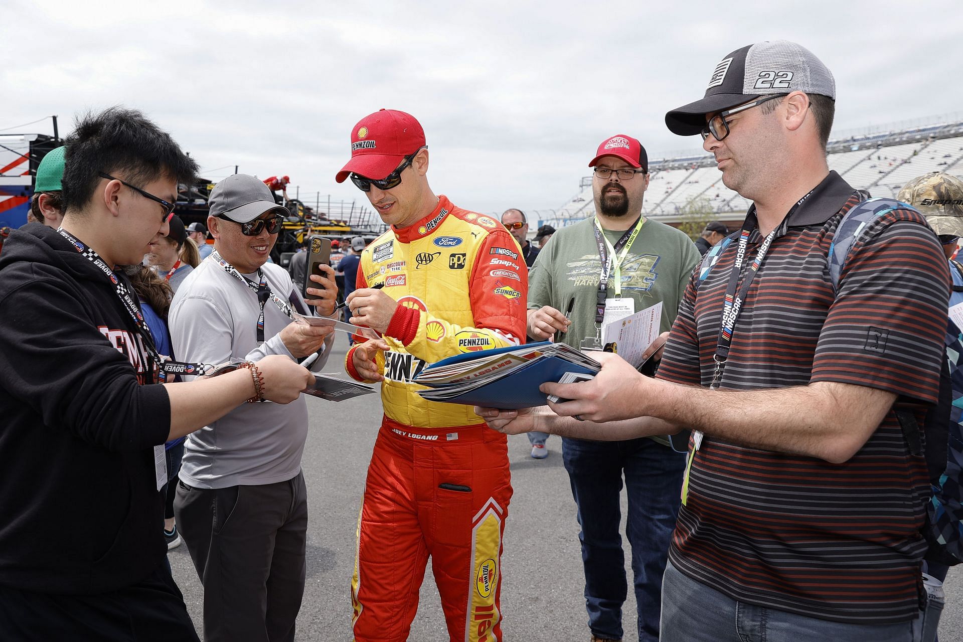 Joey Logano signs autographs for fans before the 2022 NASCAR Cup Series DuraMAX Drydene 400 presented by RelaDyne at Dover Motor Speedway in Dover, Delaware. (Photo by Tim Nwachukwu/Getty Images)