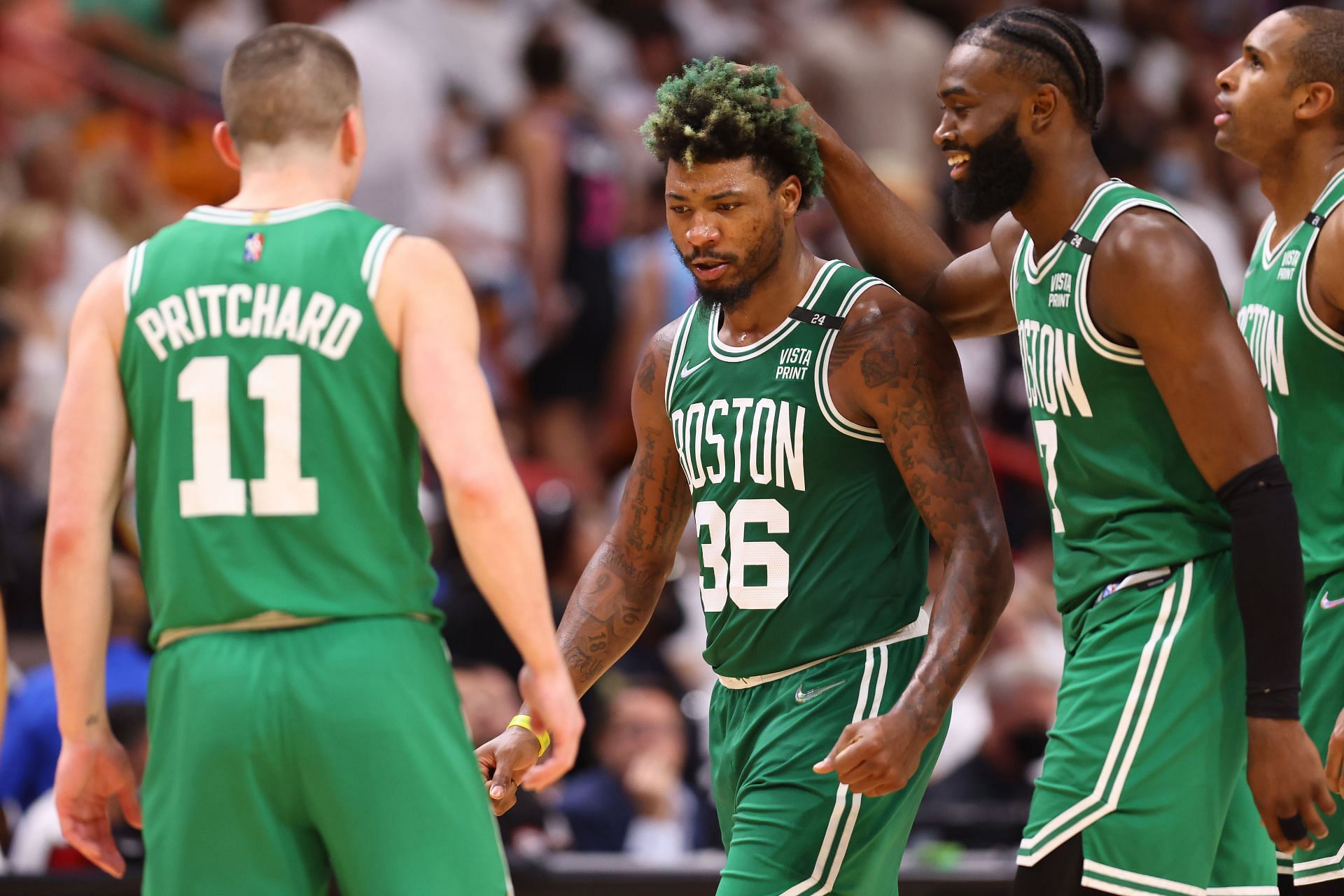 Marcus Smart #36 of the Boston Celtics celebrates with Payton Pritchard #11 and Jaylen Brown #7 against the Miami Heat
