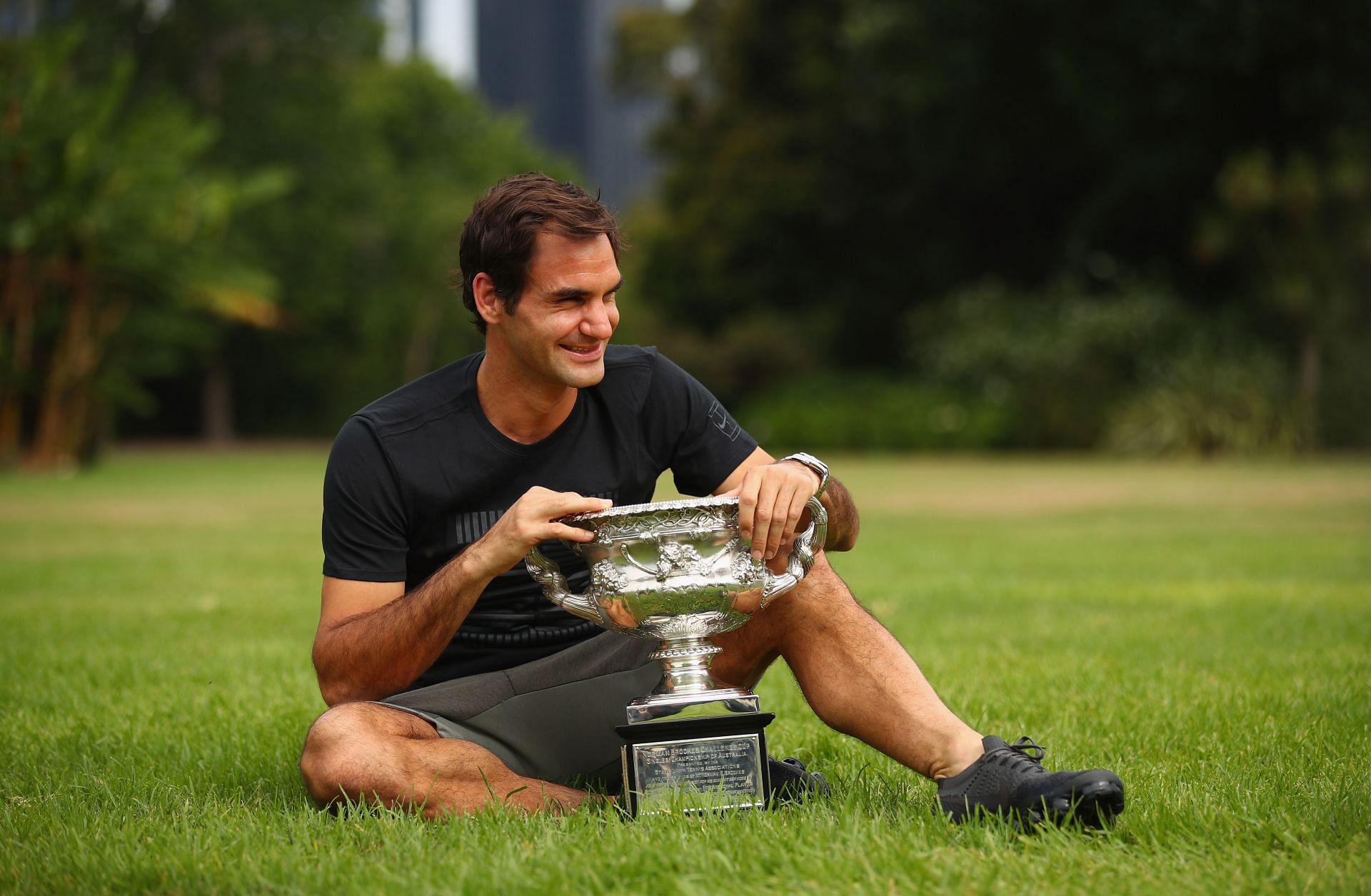 Roger Federer poses with the 2018 Australian Open trophy