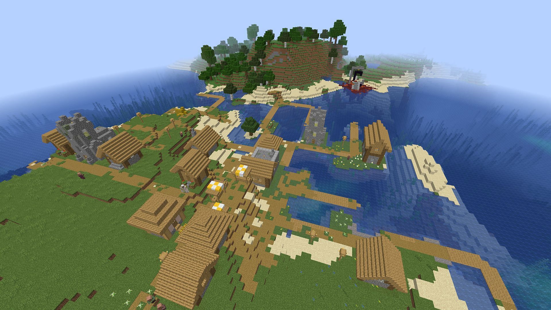 The spawn village and ruined portal (Image via Minecraft)