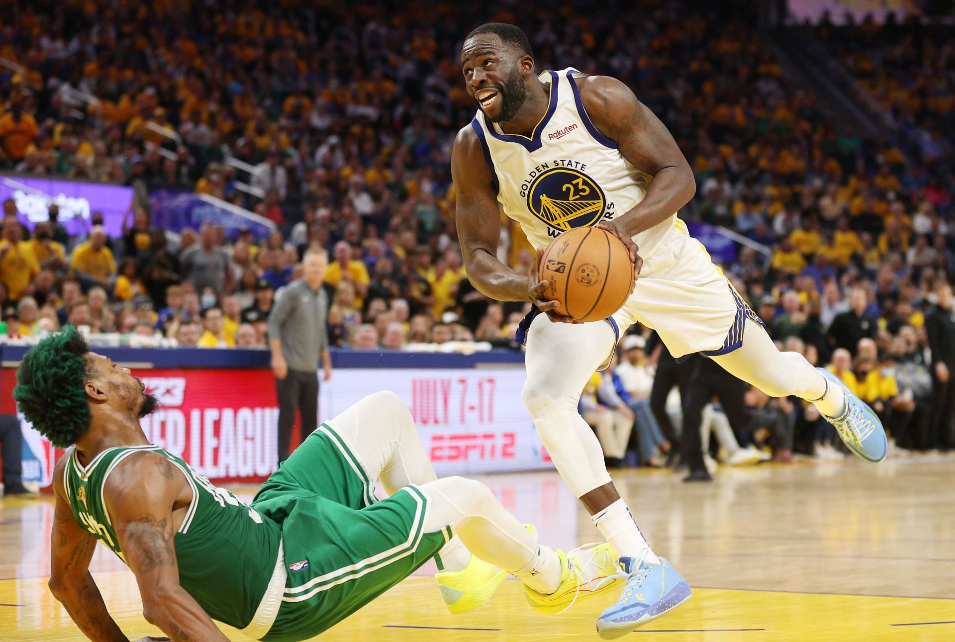 Draymond Green of the Golden State Warriors drives against Marcus Smart of the Boston Celtics