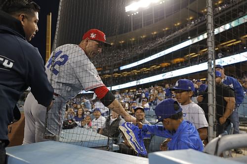 Cincinnati Reds legend interacts with fans after a game.