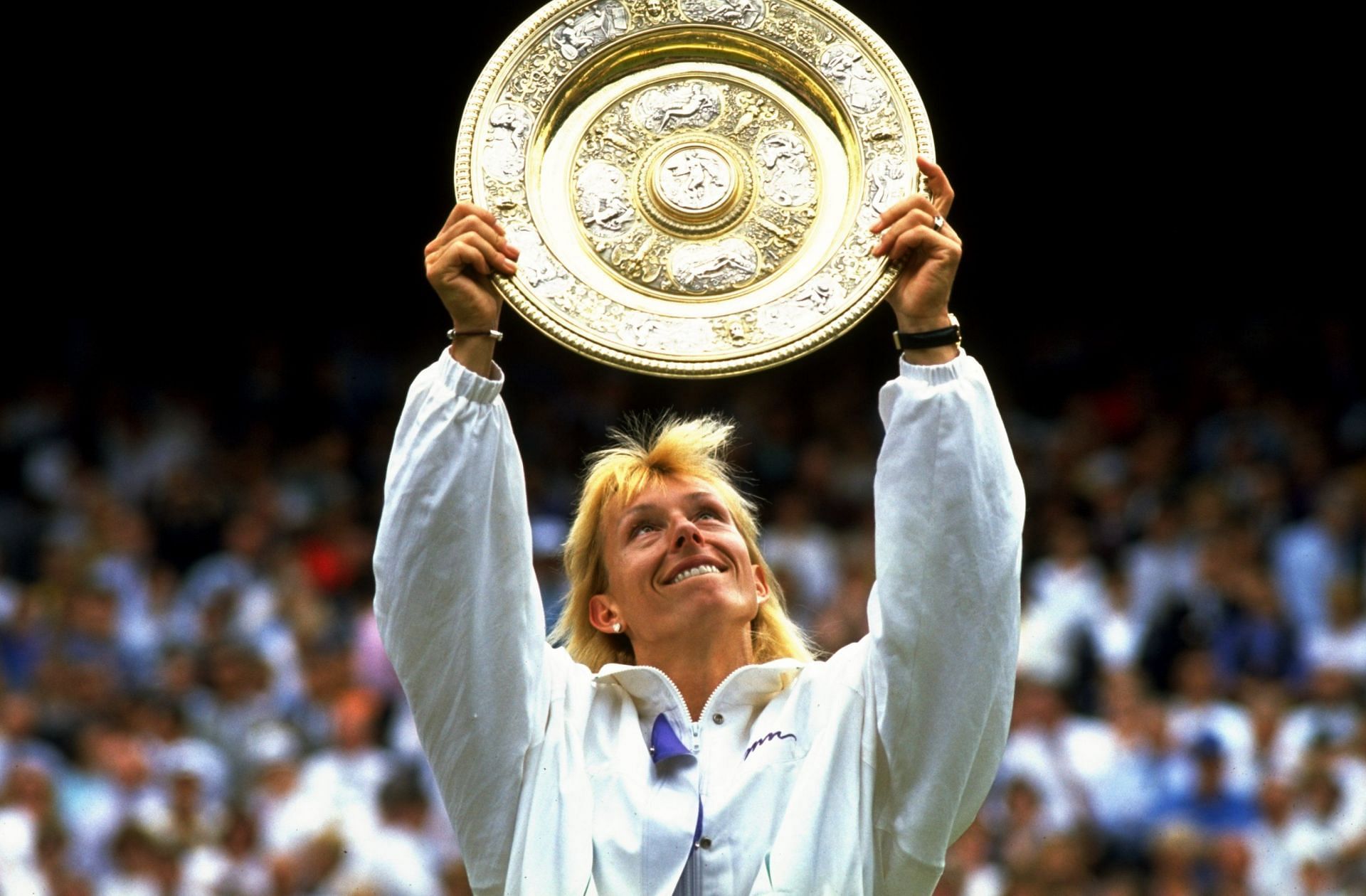 Martina Navratilova of the USA holds up the Wimbeldon winner&#039;s trophy.