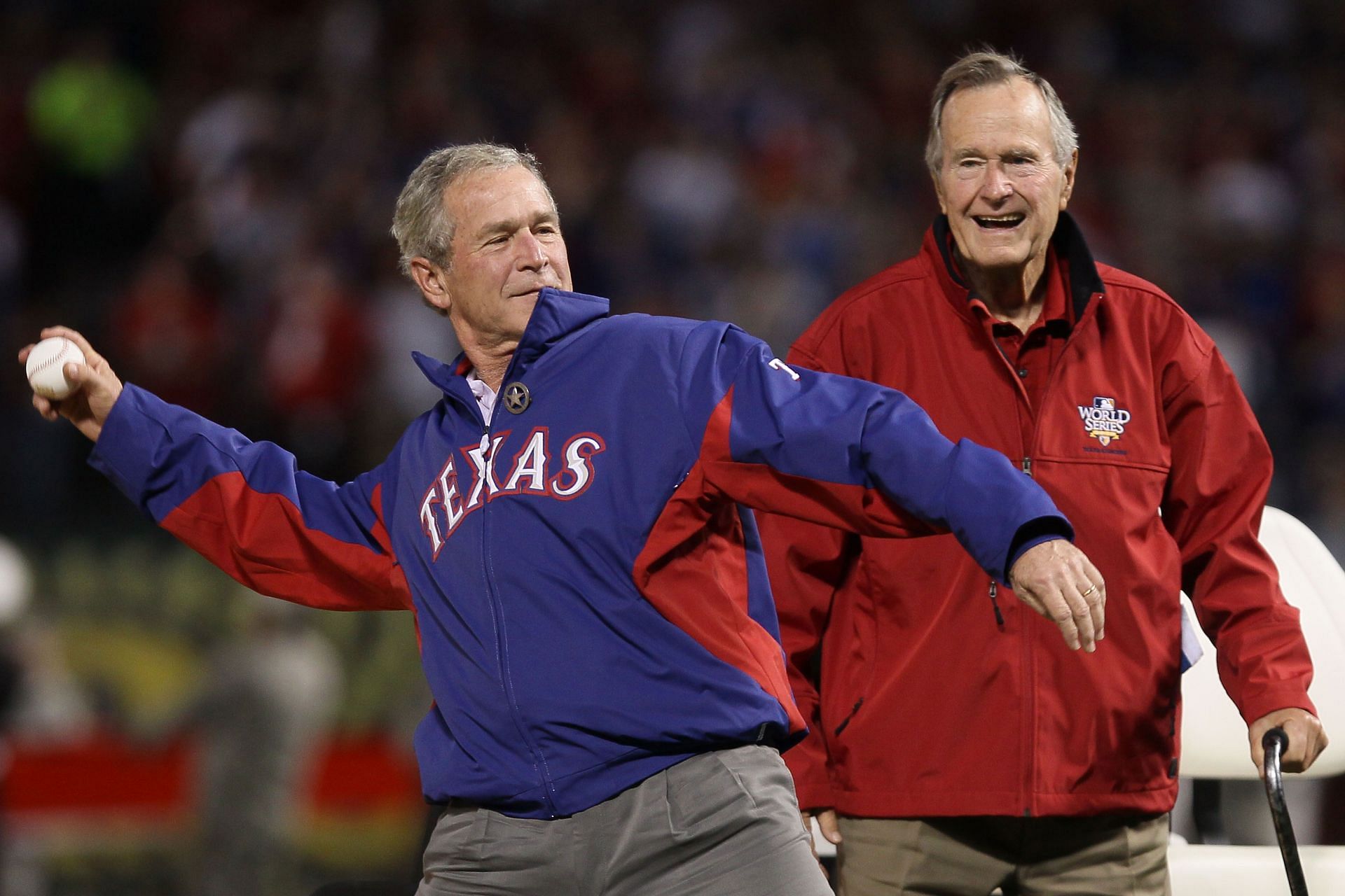 The former U. S. president, George W. Bush, throws the first pitch as his father, the former U.S. president George H.W. Bush, looks on, San Francisco Giants v Texas Rangers.