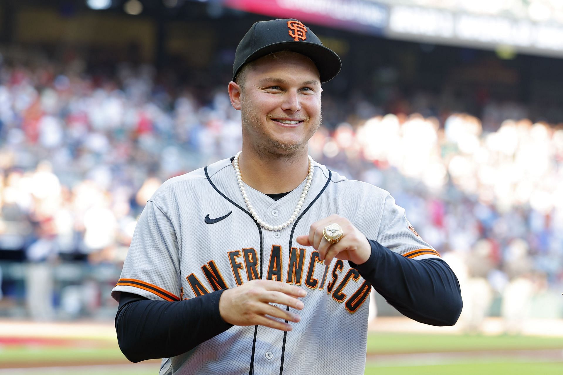 Joc Pederson of the San Francisco Giants receives his World Series Championship ring from the 2021 season with the Atlanta Braves.