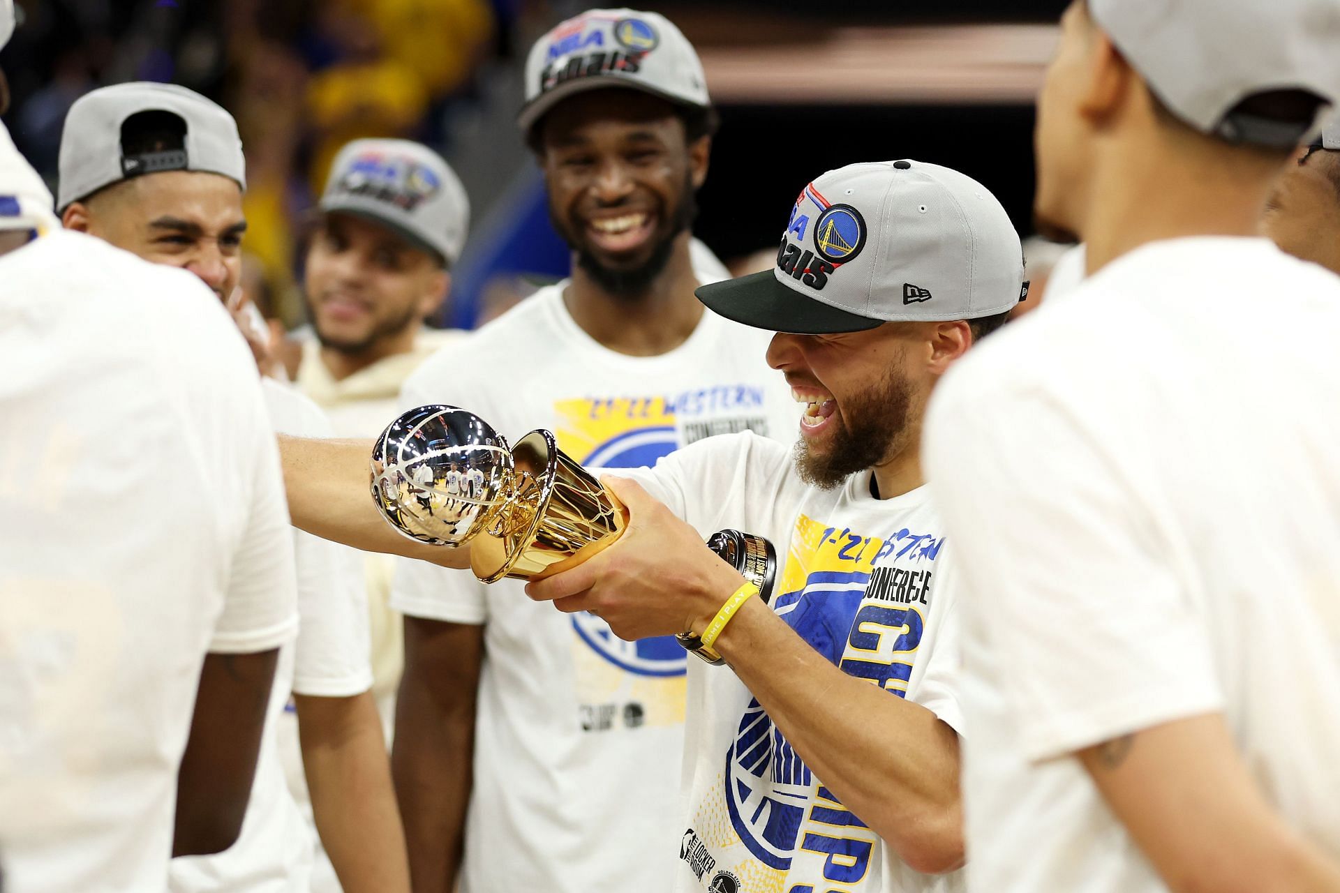 Steph Curry of the Golden State Warriors celebrates winning the Magic Johnson WCFMVP trophy