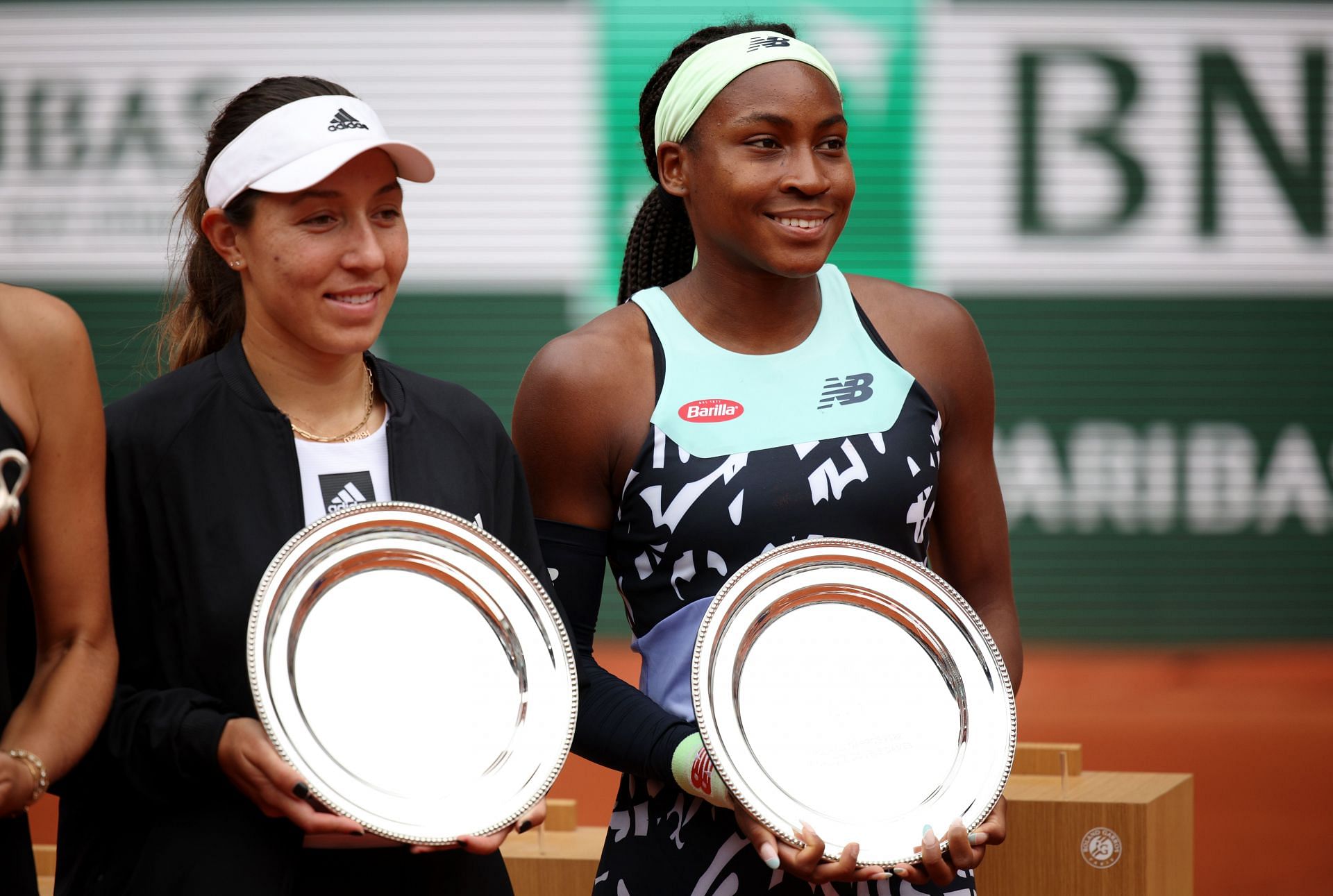 Coco Gauff and Jessica Pegula pose with the doubles runners-up trophy at the French Open