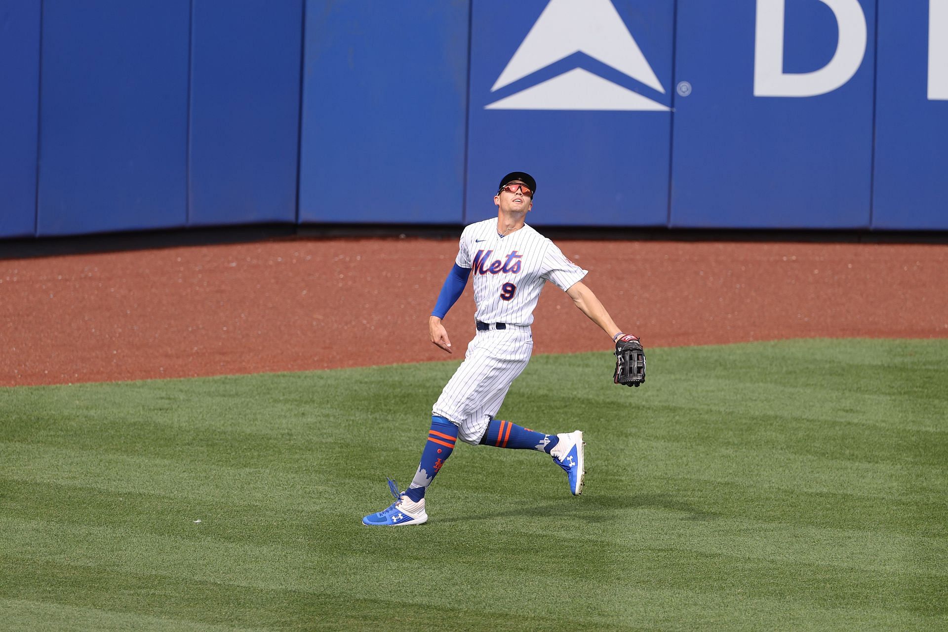 Brandon Nimmo goes back to catch a ball during a Atlanta Braves v New York Mets game.