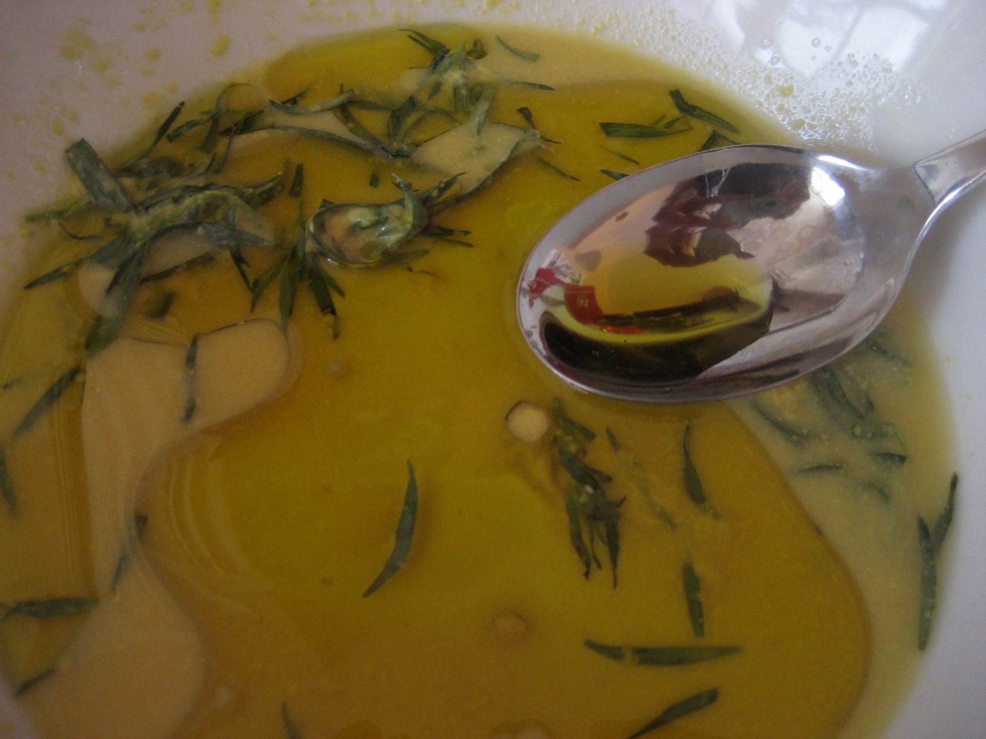 Tarragon flavored oil is an excellent addition to salads and soups (Image via Flickr @kattebelletje)