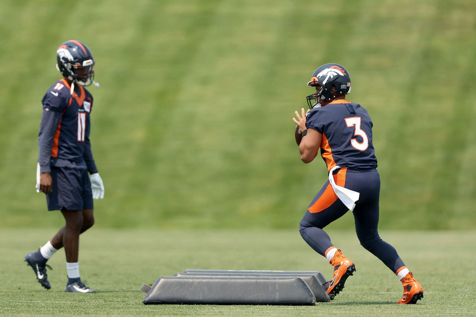 Denver Broncos quarterback Russell Wilson warms up at mandatory minicamp