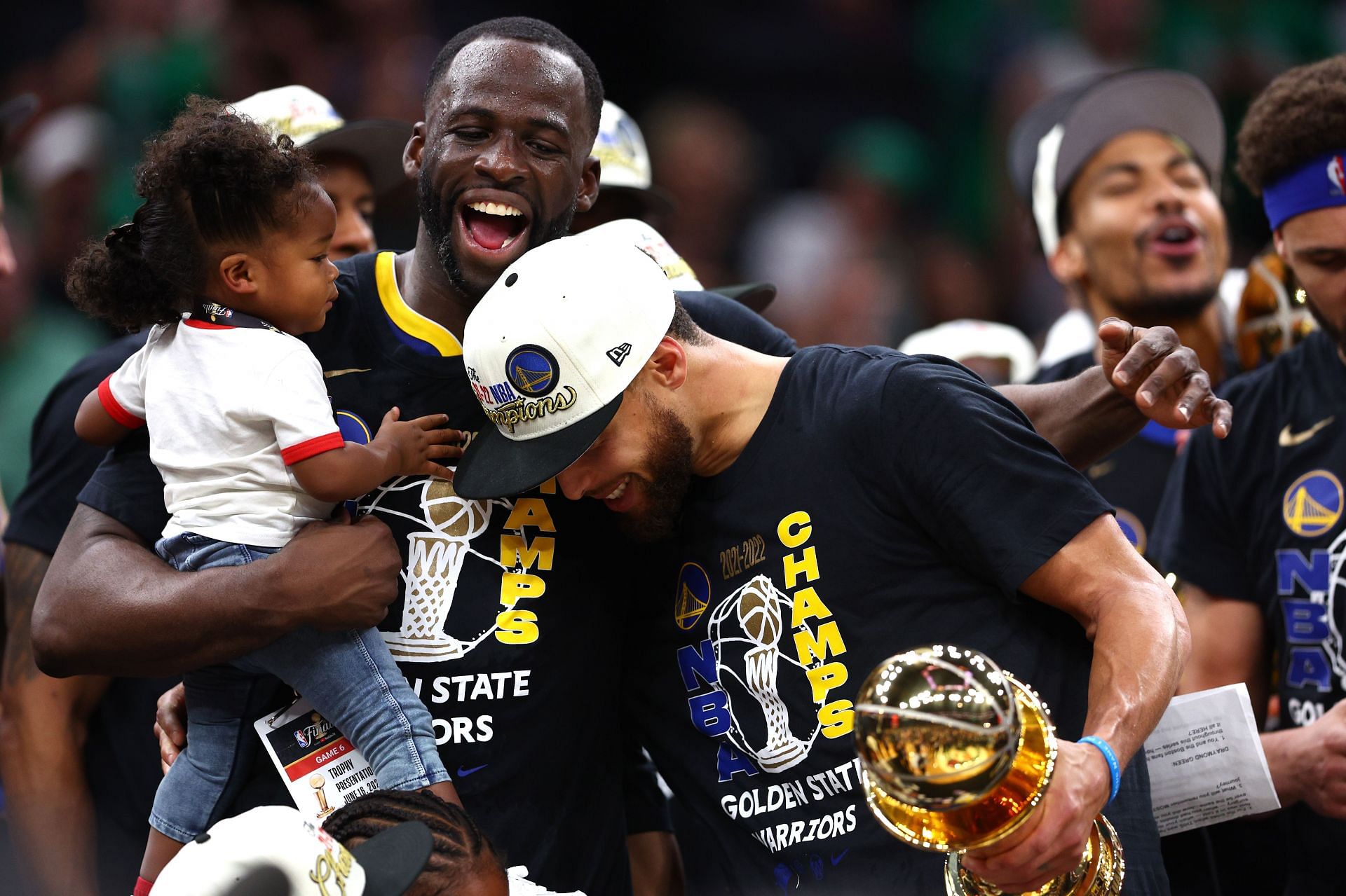 Stephen Curry of the Golden State Warriors celebrates with Draymond Green and his daughter Kyla Green.