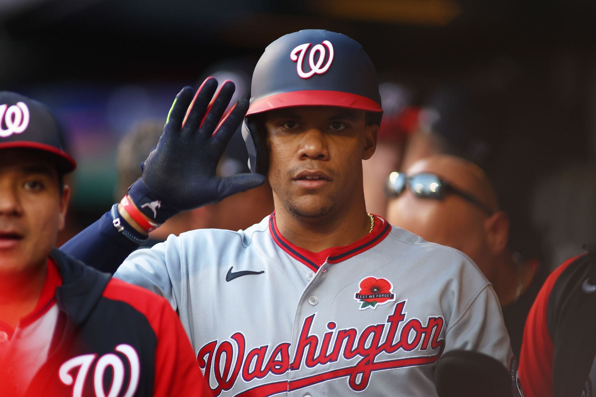 Juan Soto waves to the camera from the Washington Nationals dugout.