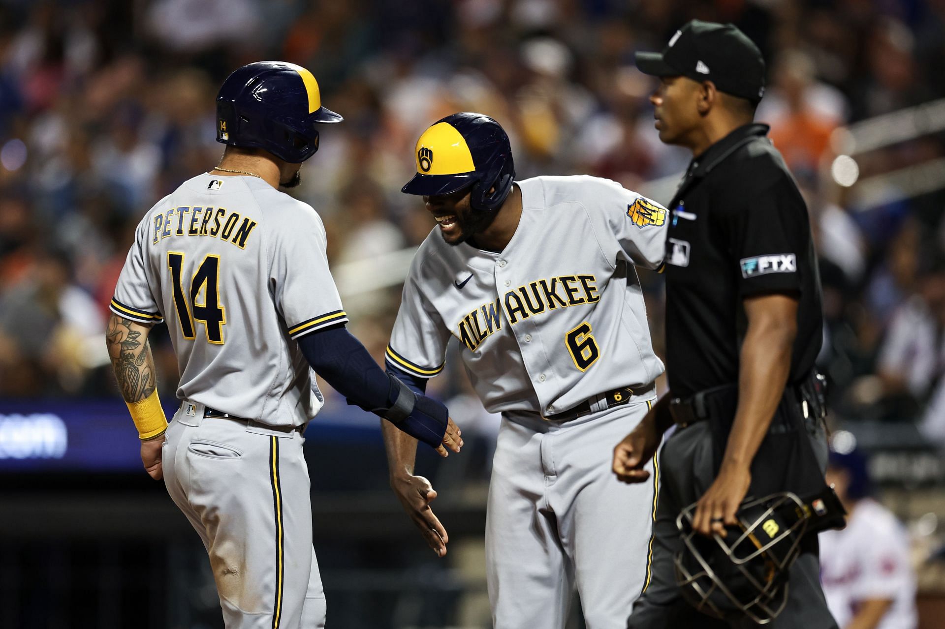 Jace Peterson greets Lorenzon Cain after scoring a run during tonight&#039;s Brewers v Mets game.