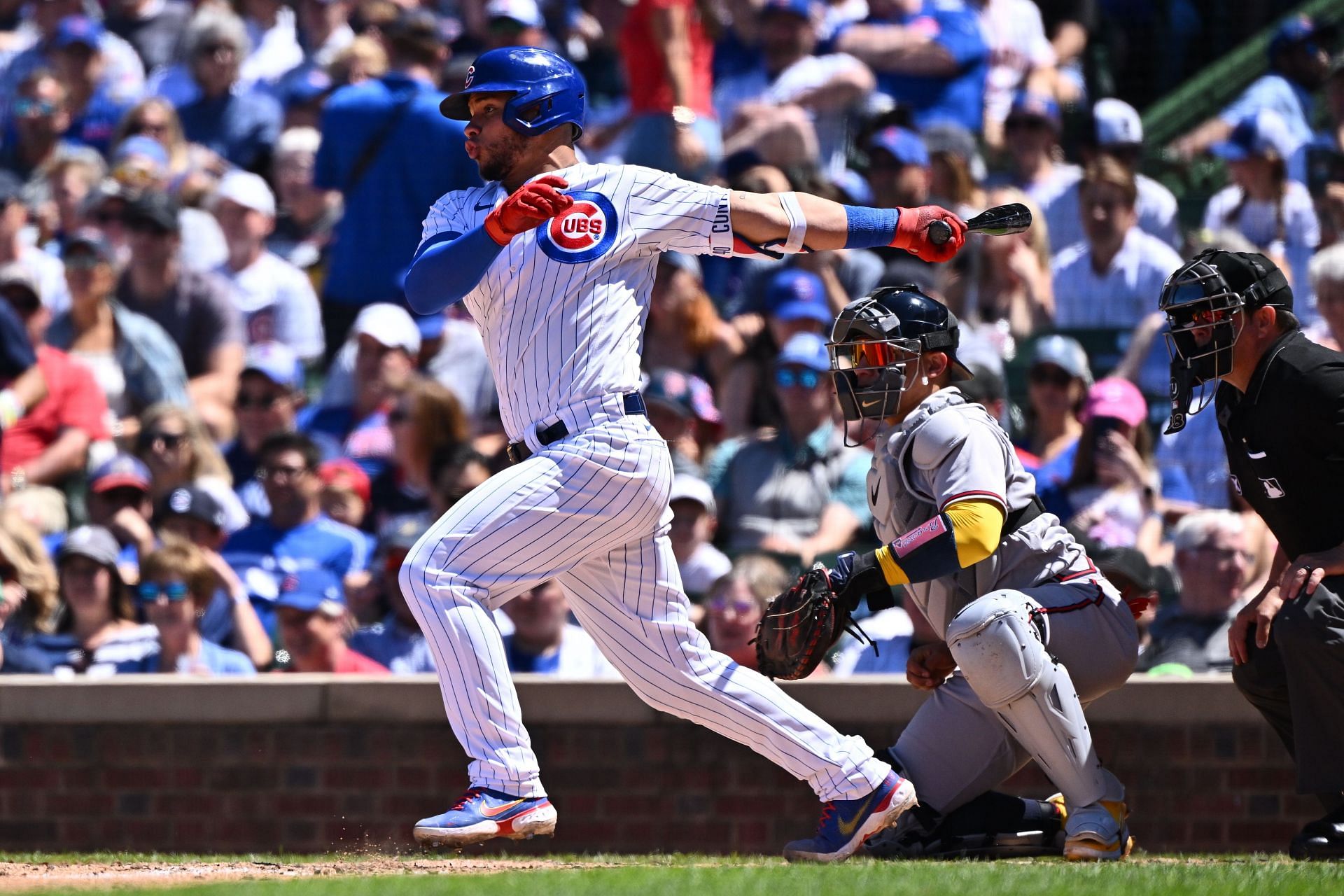 Willson Contreras hits a line drive to left field during a Atlanta Braves v Chicago Cubs game at Wrigley Field.