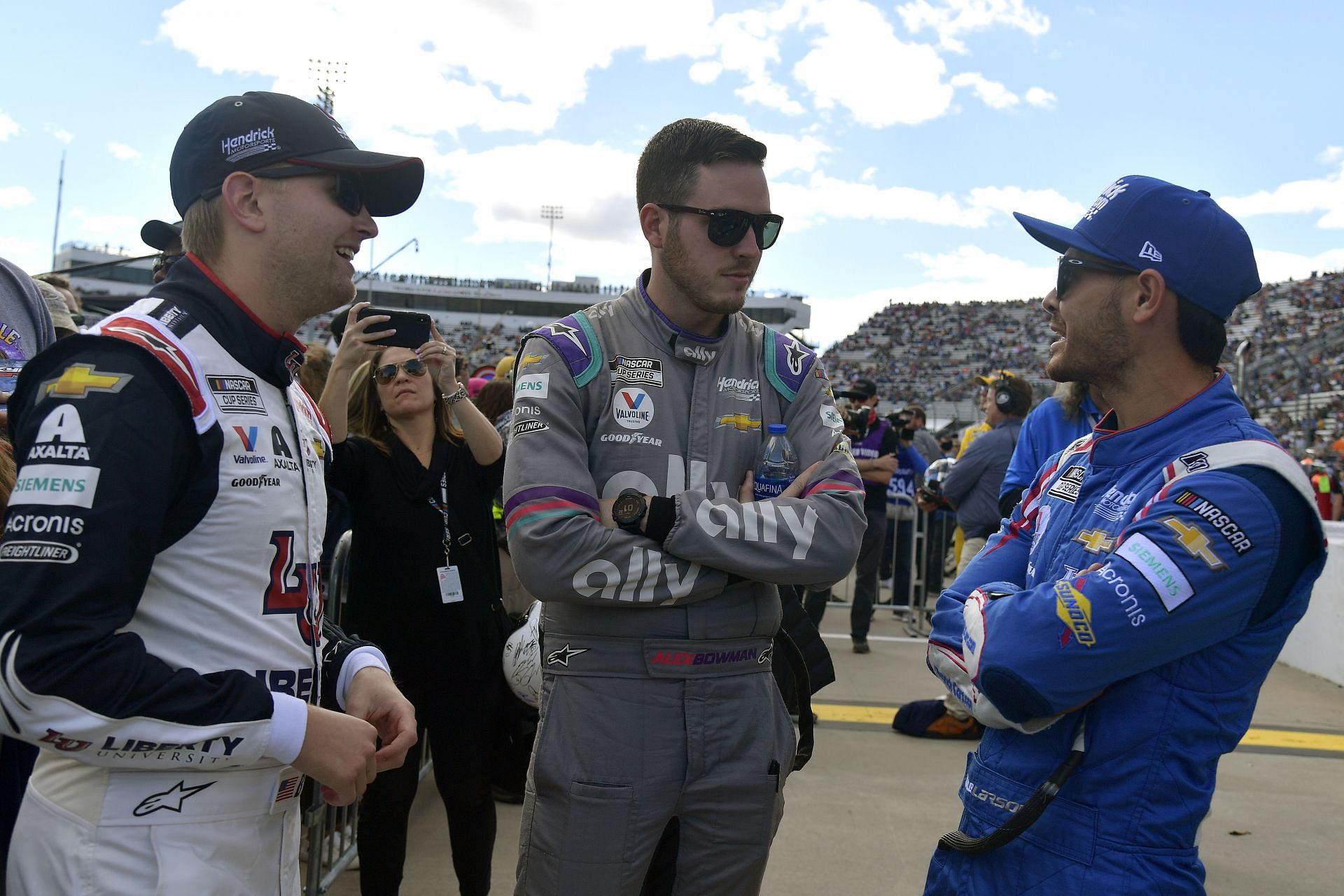 William Byron (L), Alex Bowman (C) and Kyle Larson (R) talk backstage of pre-race ceremonies prior to the NASCAR Cup Series Xfinity 500 at Martinsville Speedway.