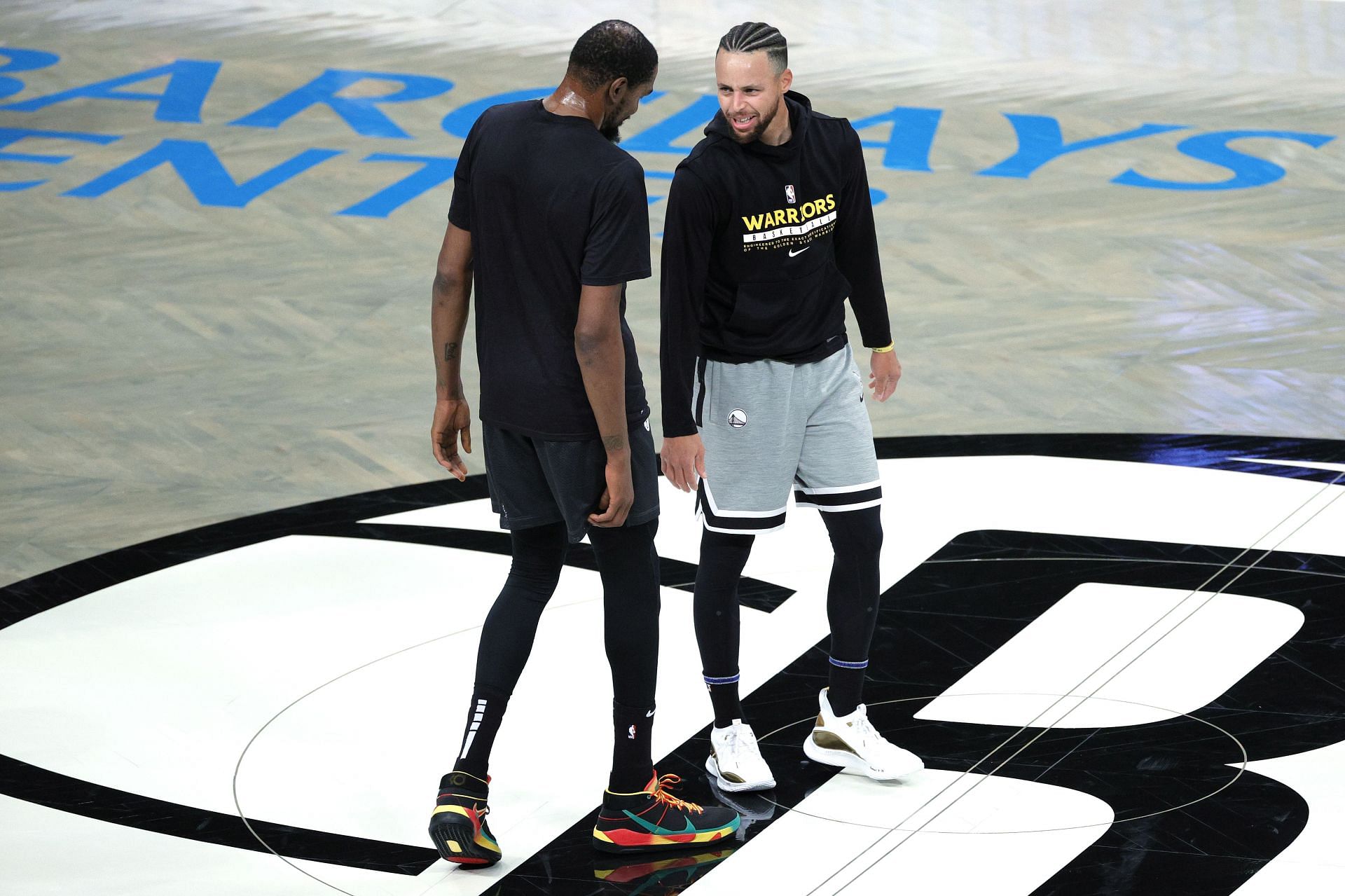 Steph Curry talking to Kevin Durant before their match against each other.