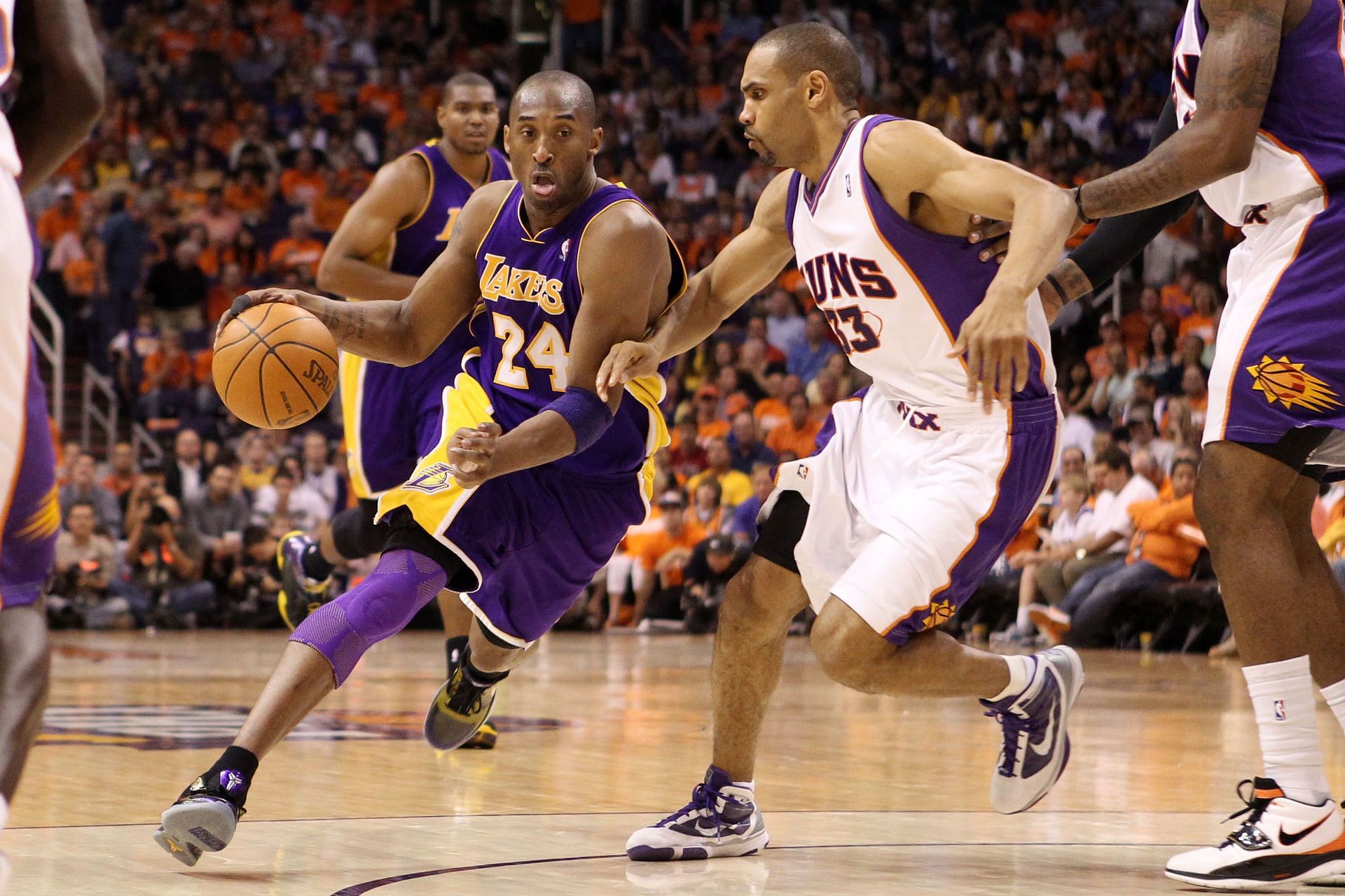 Kobe Bryant of the LA Lakers drives past Grant Hill of the Phoenix Suns.