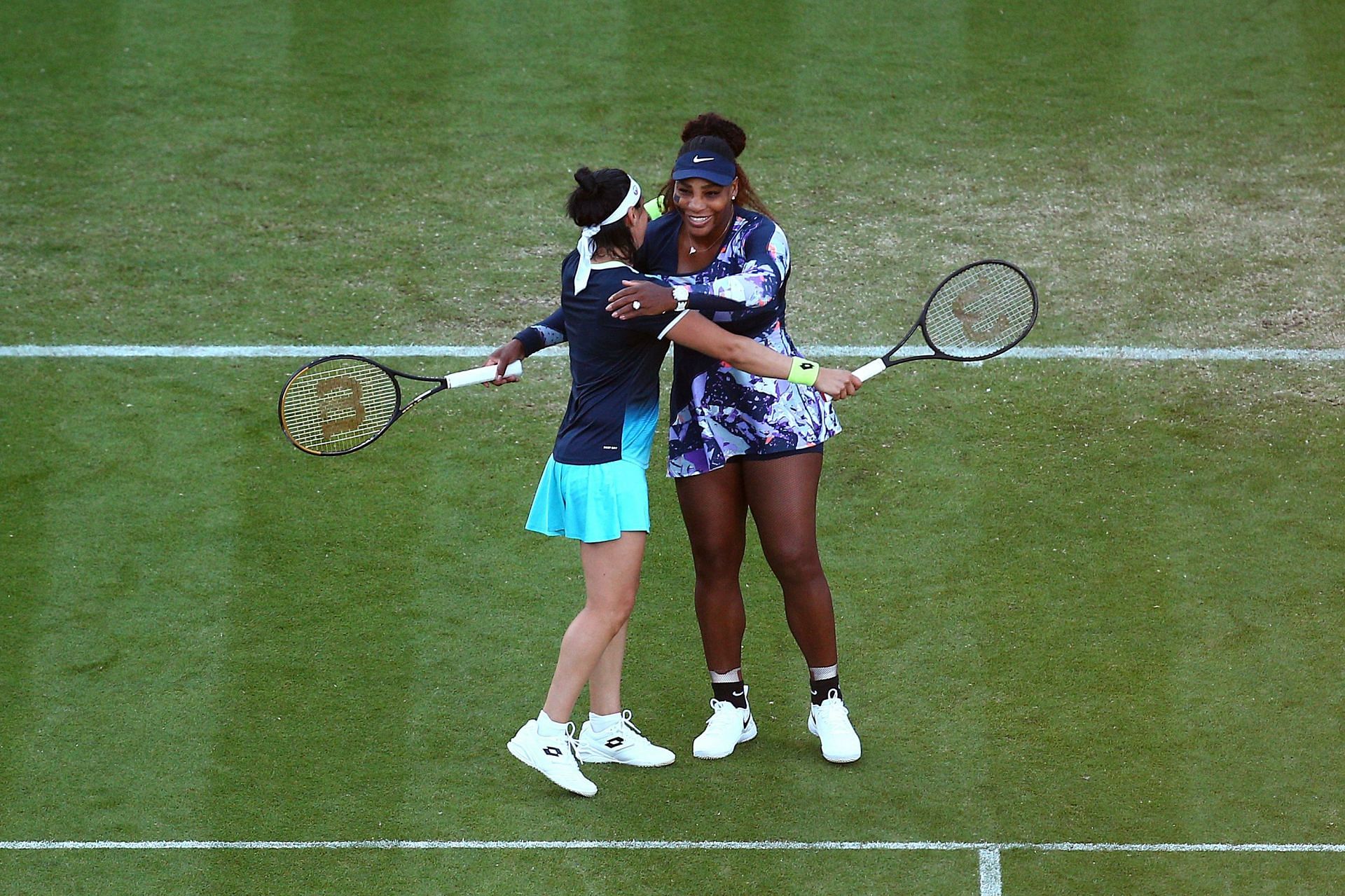 Serena Williams and Ons Jabeur share a hug as they mark their second win as a pair