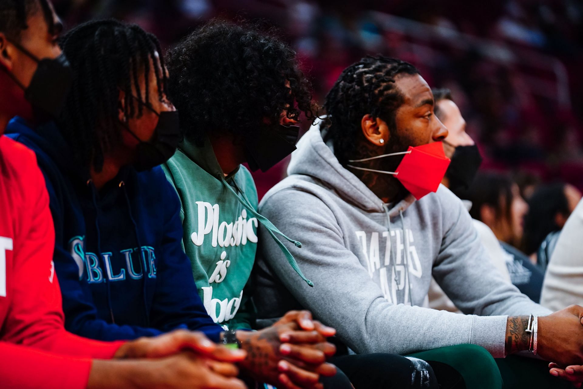 John Wall watches a game from the bench
