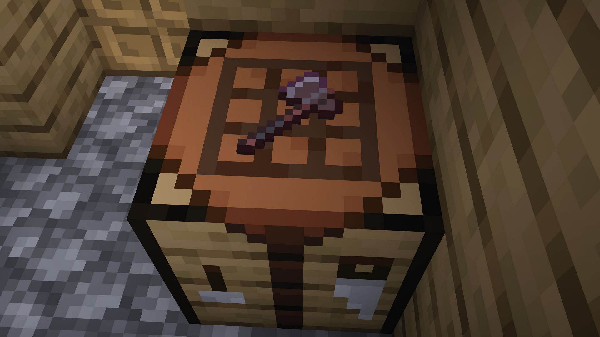 An axe placed on a crafting table with the help of the invisible item frame (Image via Minecraft 1.19)