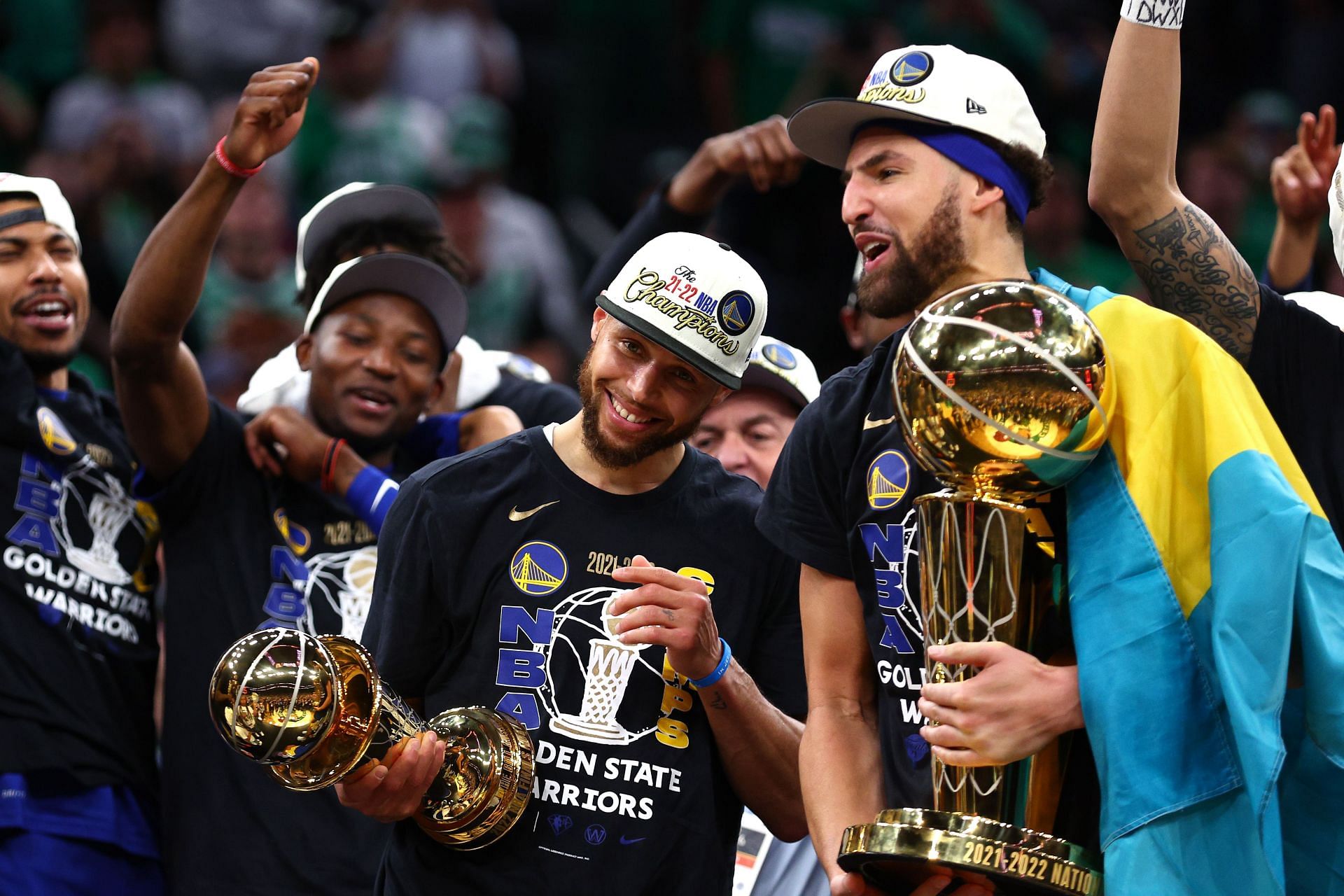 Curry and Thompson celebrate with the trophies in the 2022 NBA Finals - Game 6