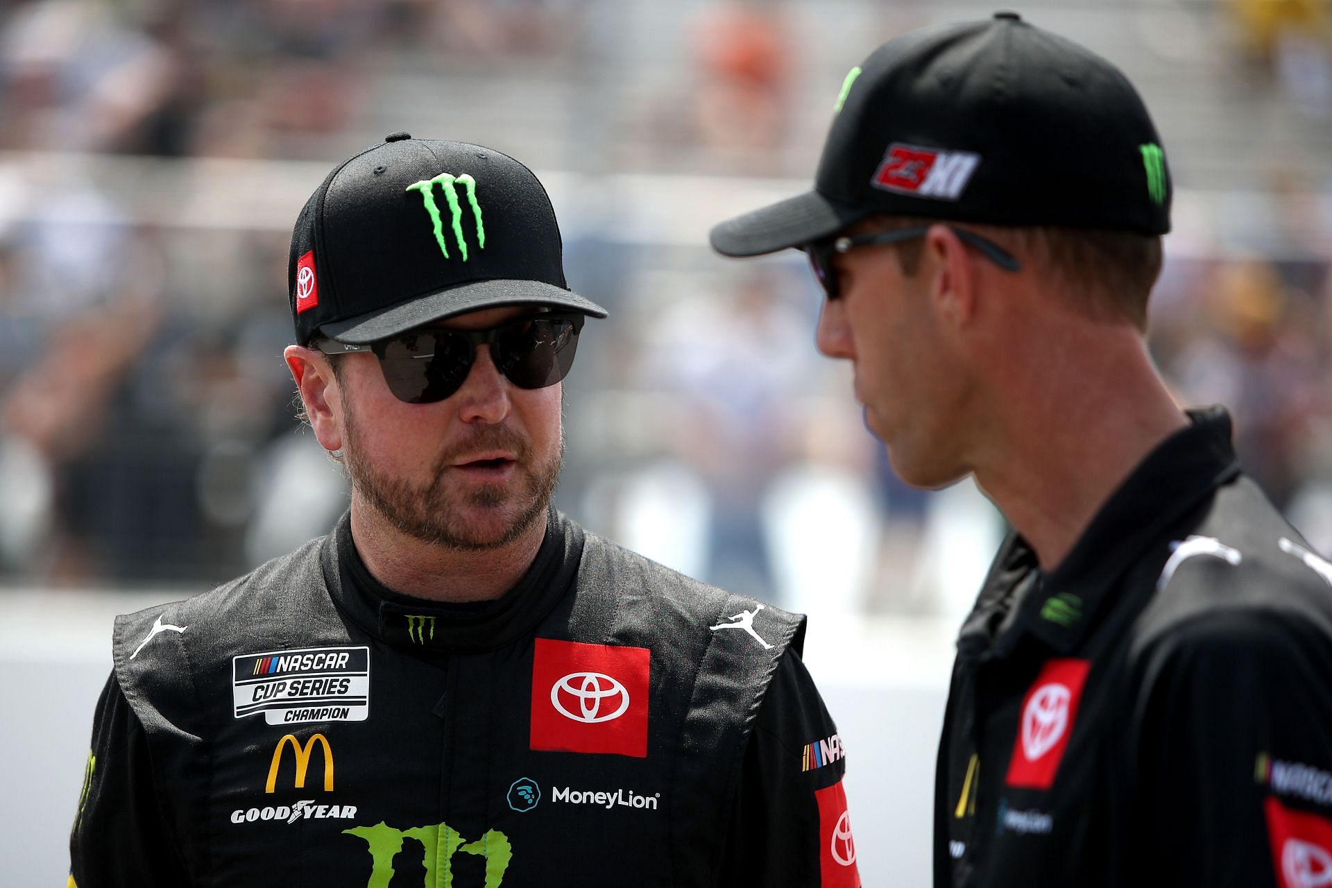 Kurt Busch (left) speaks to a crew member on the grid before the NASCAR Cup Series Enjoy Illinois 300 at WWT Raceway