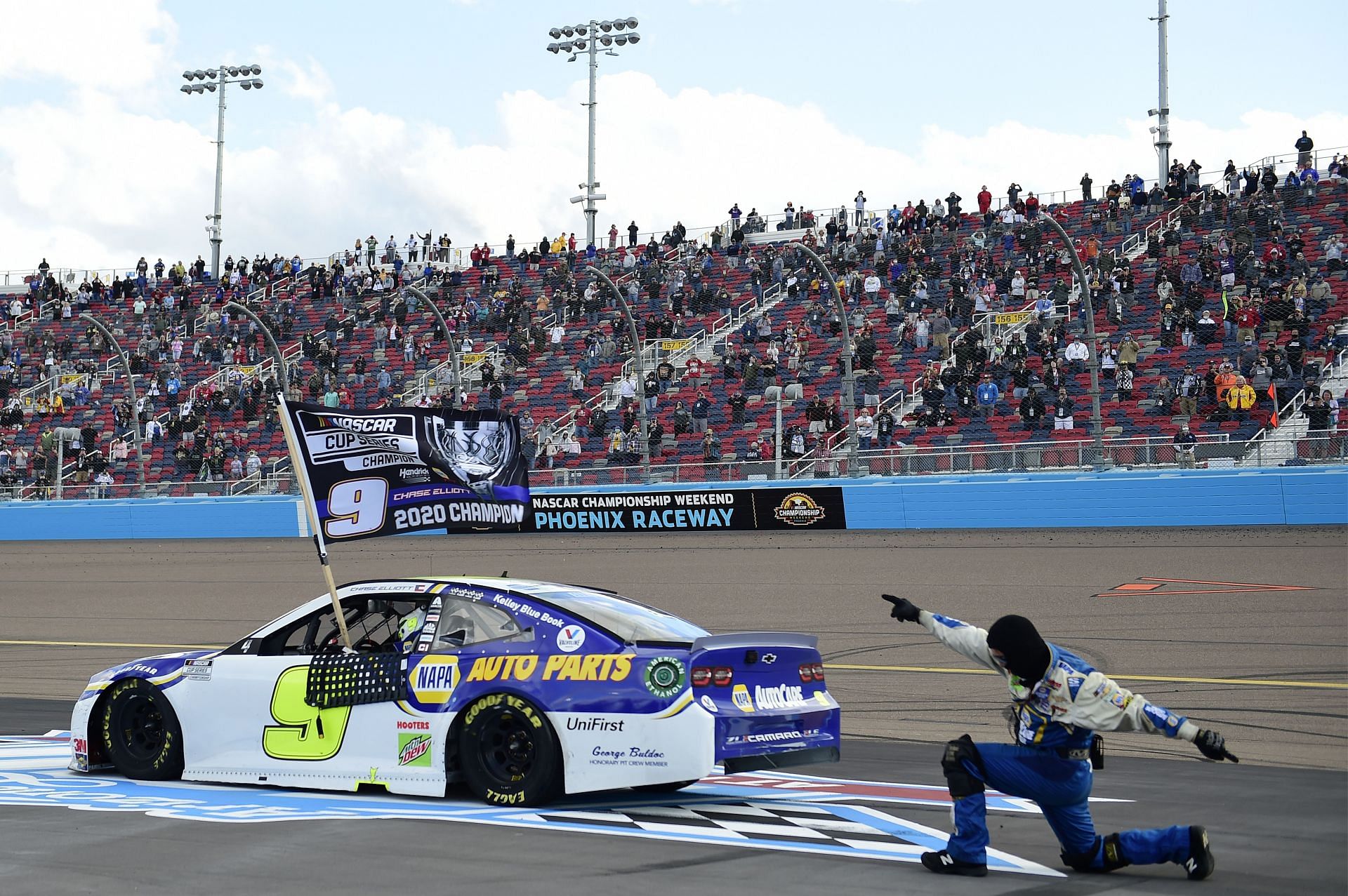 Chase Elliott and a pit crew member celebrate after winning the 2020 NASCAR Cup Series Season Finale 500 and the 2020 NASCAR Cup Series Championship at Phoenix Raceway in Avondale, Arizona. (Photo by Jared C. Tilton/Getty Images)