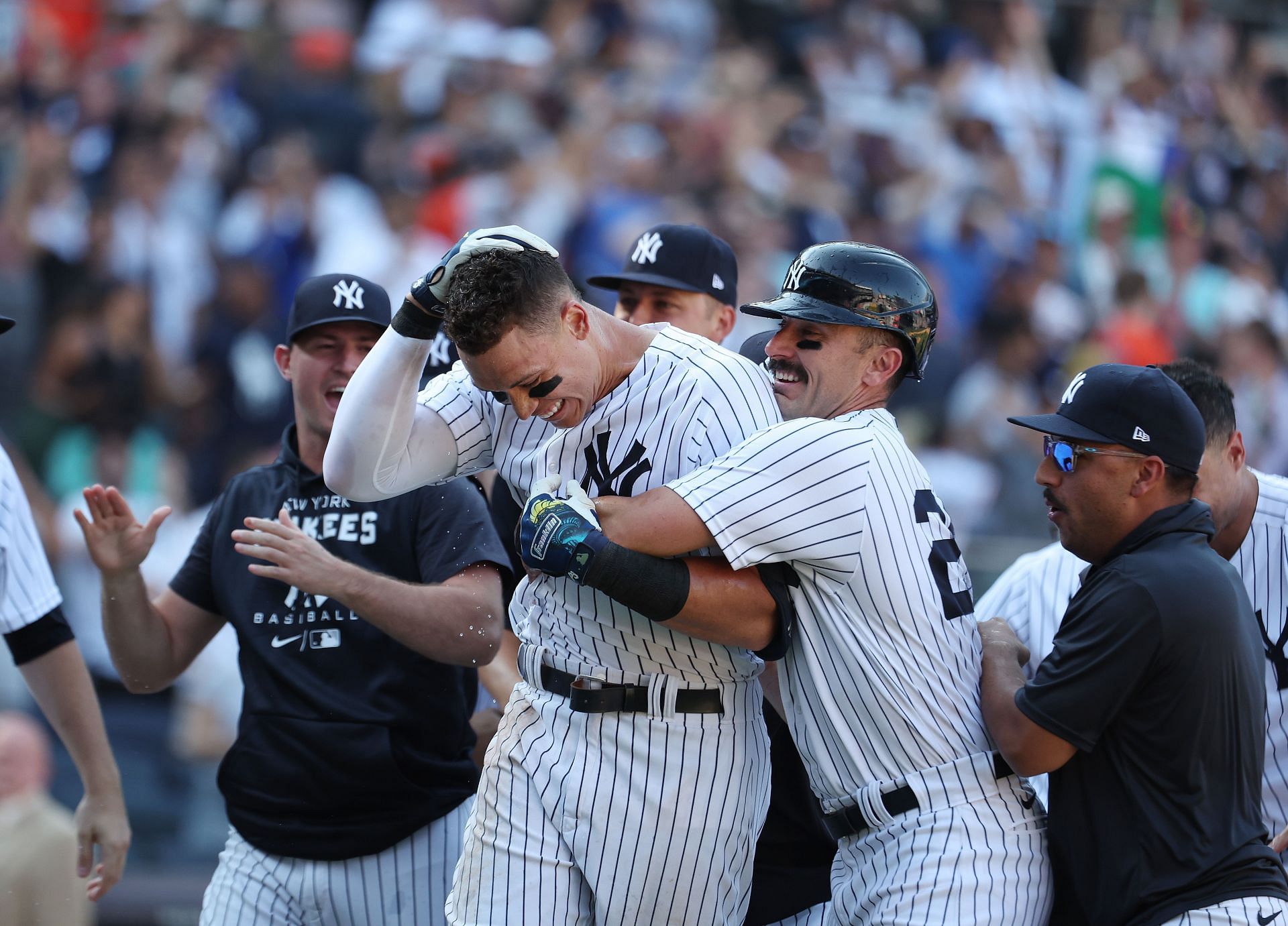 Aaron Judge of the New York Yankees is greeted by his team after hitting a walk-off tenth-inning three-run home run.