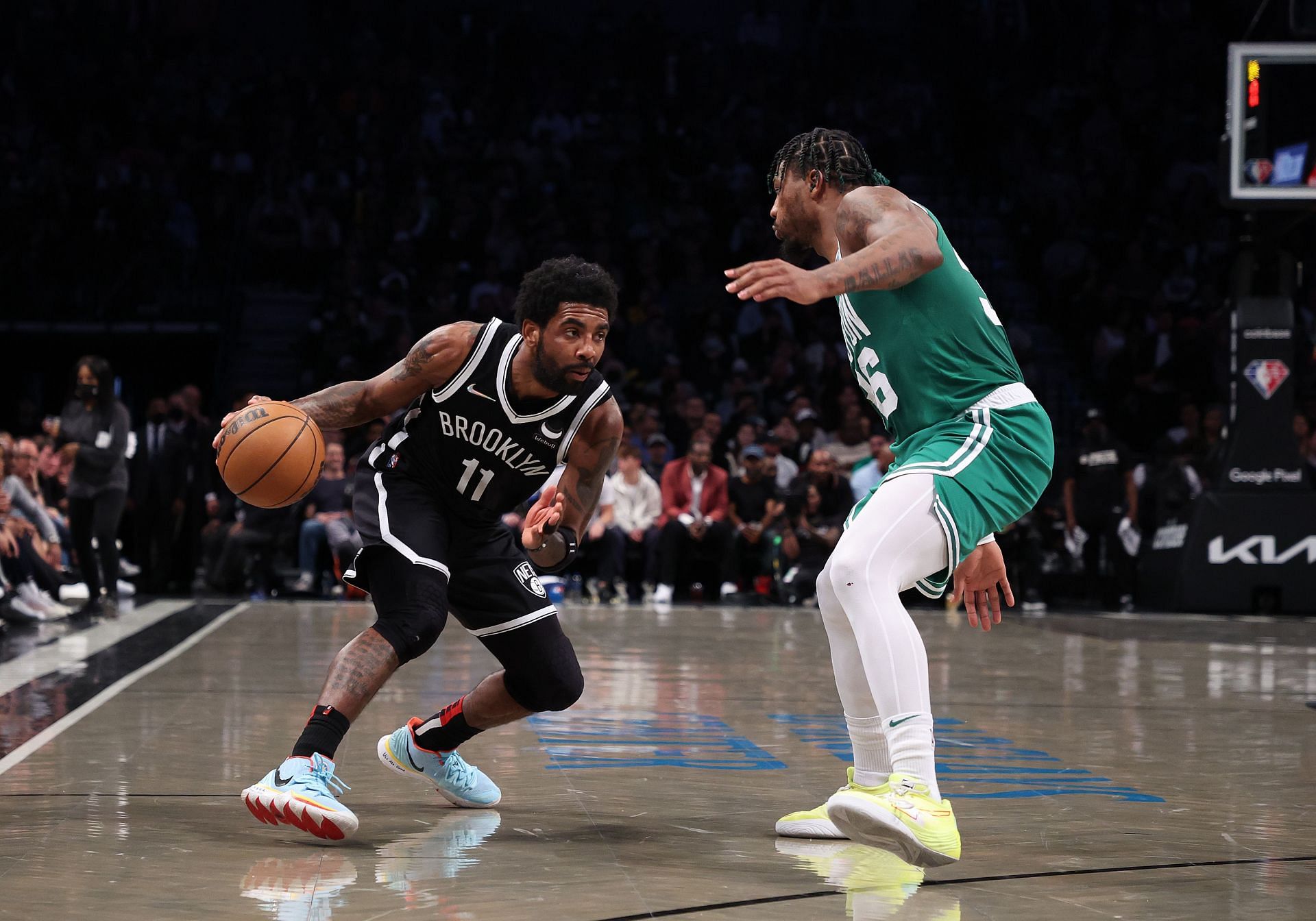 Kyrie Irving (left) attempts to dribble past Marcus Smart during the 2021-22 NBA Playoffs