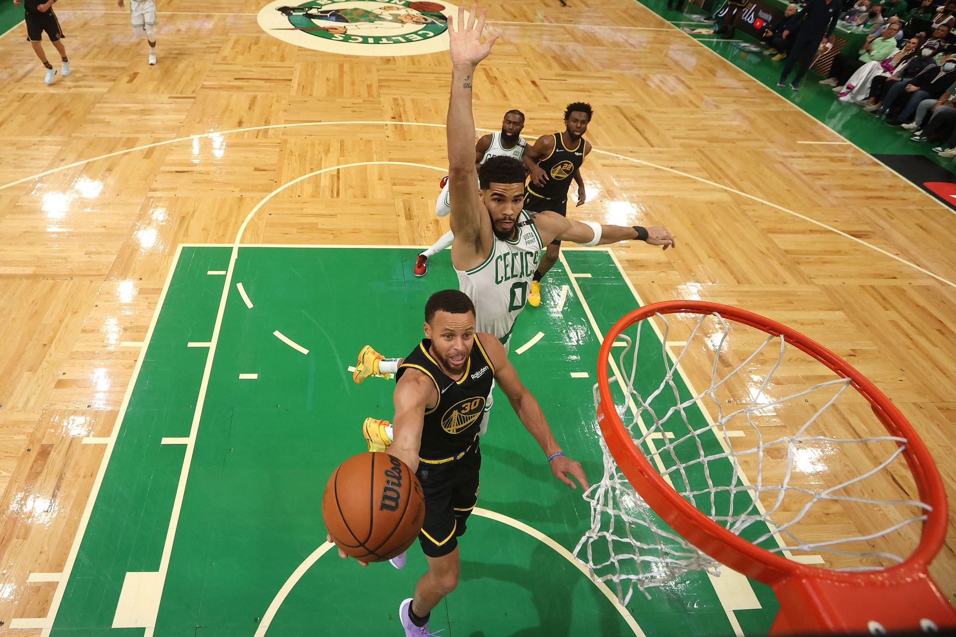 Game 4, NBA Finals: Steph Curry goes for a layup as Jayson Tatum attempts a block from behind.