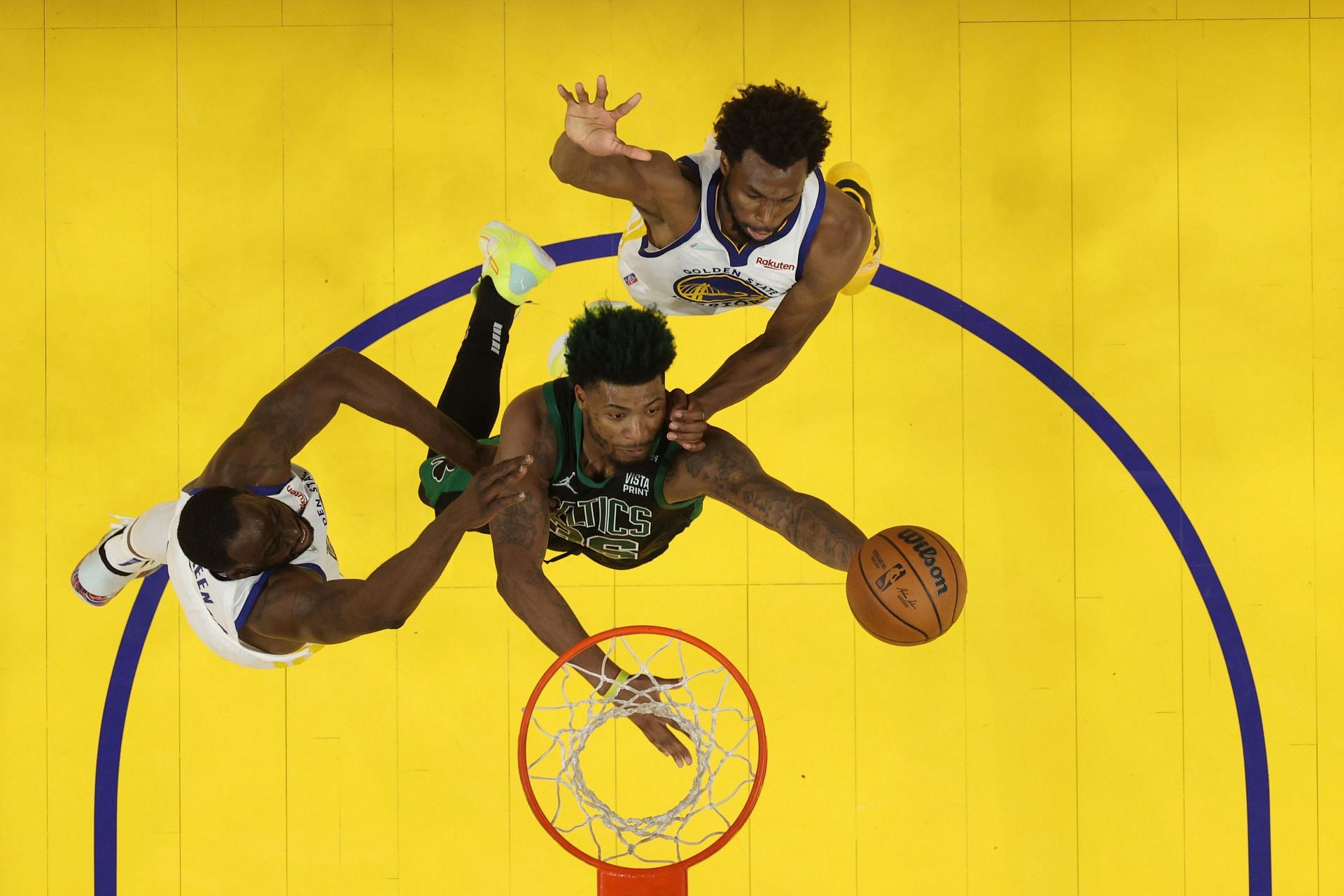 Marcus Smart of the Boston Celtics drives to the basket against Draymond Green, left, and Andrew Wiggins of the Golden State Warriors during the third quarter of Game 5 in the NBA Finals at Chase Center on Monday in San Francisco, California. The Golden State Warriors won 104-94.