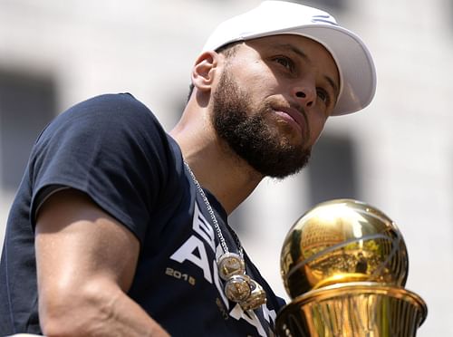 Stephen Curry of the Golden State Warriors celebrates with NBA Finals MVP Award during a parade on Monday in San Francisco, California. The Warriors beat the Boston Celtics 4-2 to win the NBA Finals.