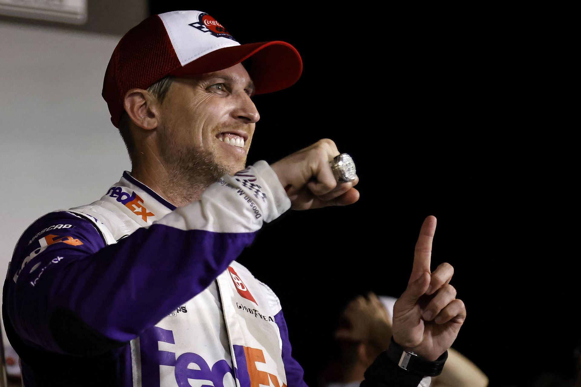 Denny Hamlin displays his Coca-Cola 600 ring in victory lane after winning the NASCAR Cup Series Coca-Cola 600 at Charlotte Motor Speedway