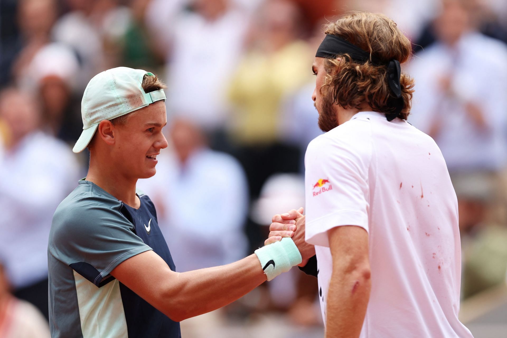 Holger Rune and Stefanos Tsitsipas shake hands after thier match at the 2022 French Open