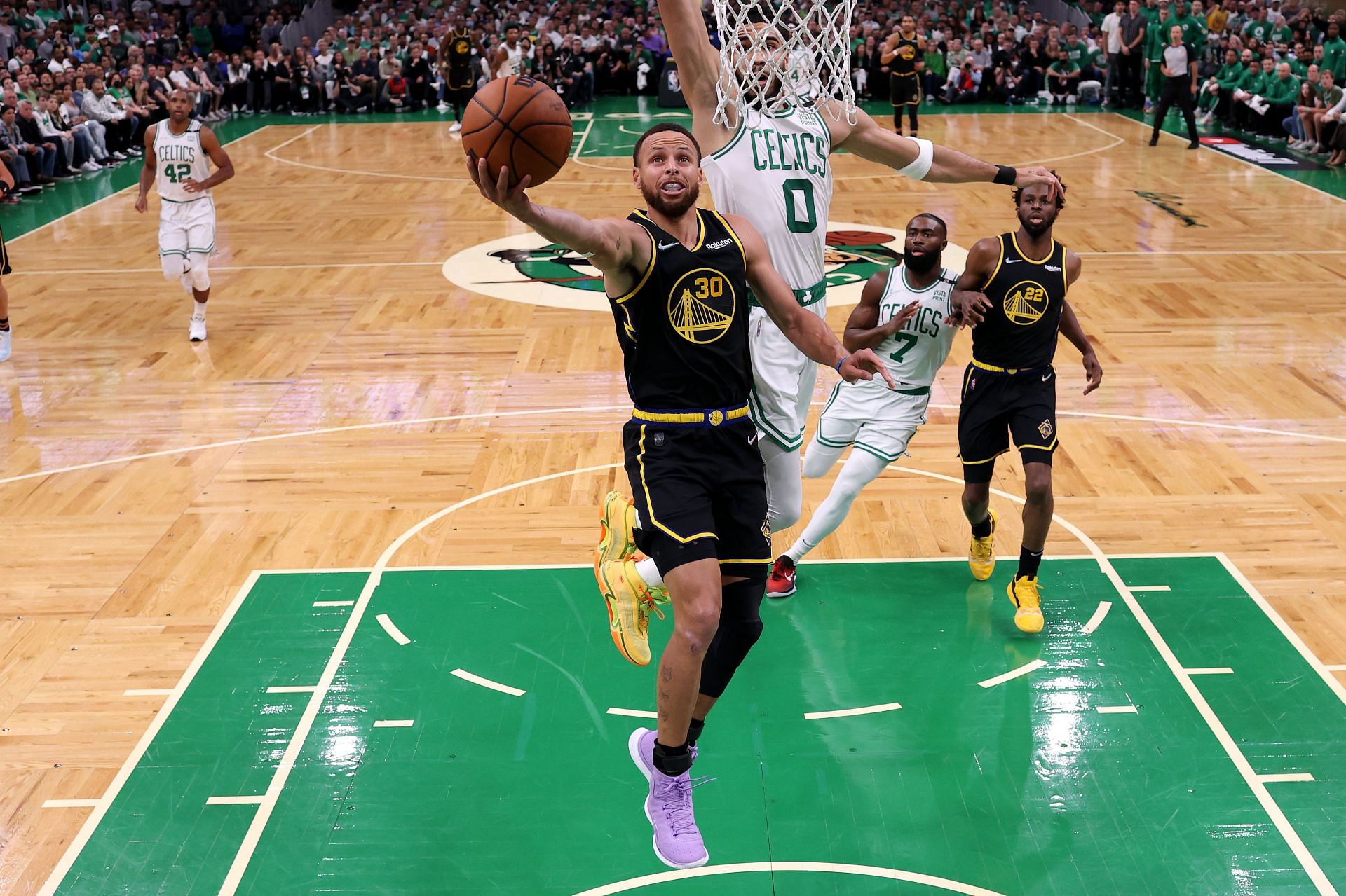 Steph Curry of the Golden State Warriors drives to the basket against Jayson Tatum #0 of the Boston Celtics